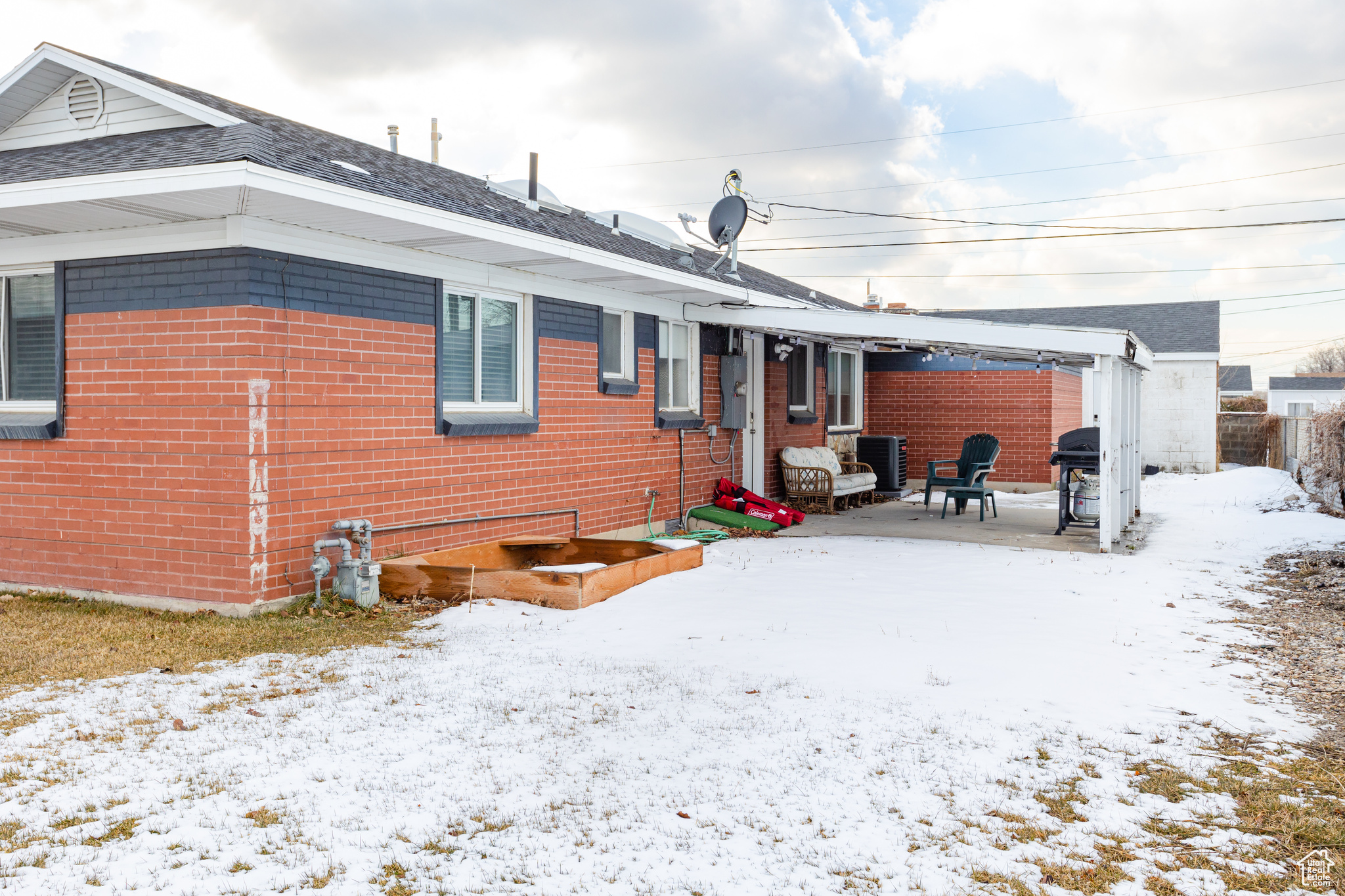 View of snow covered back of property