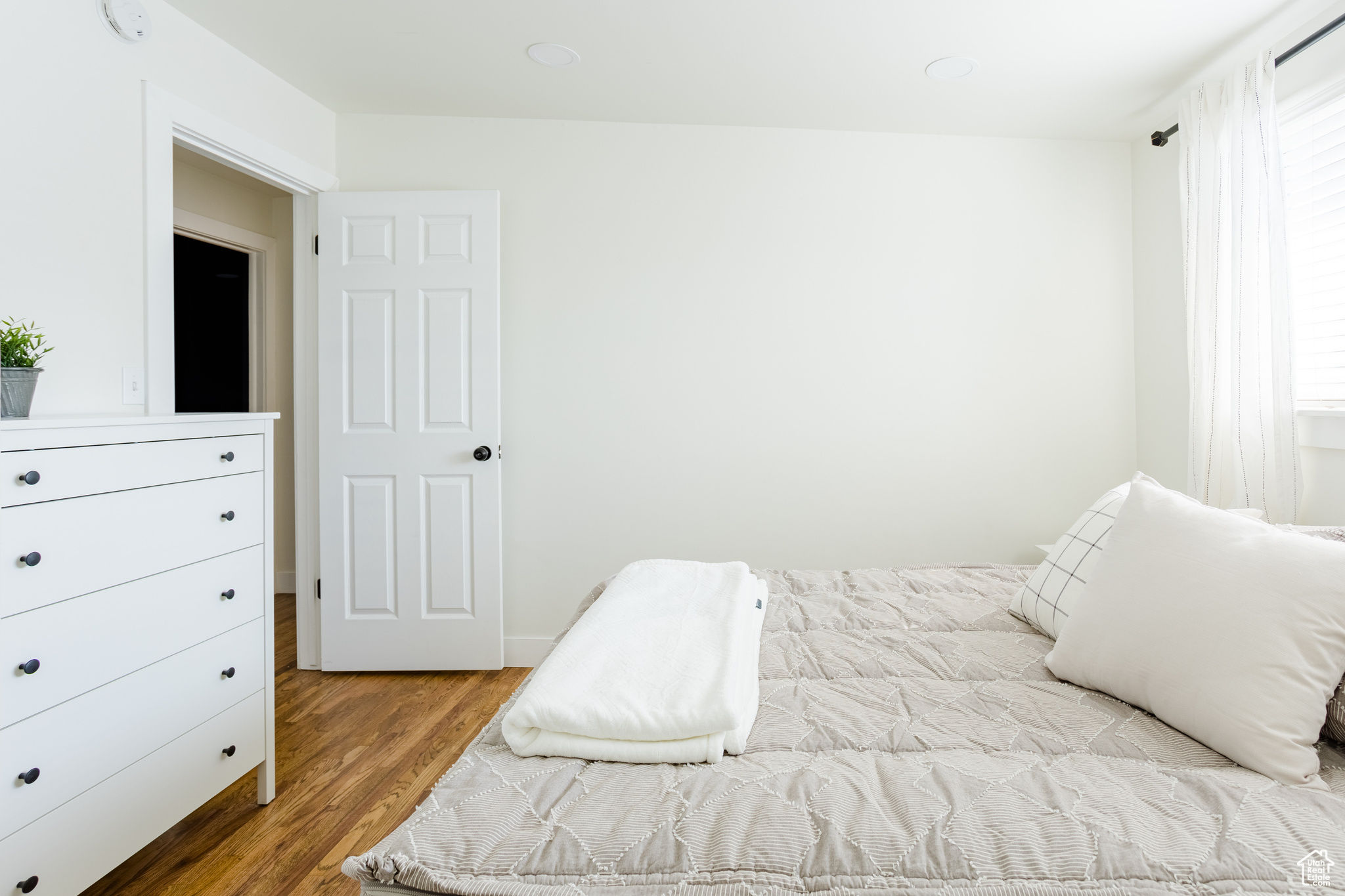 Bedroom with hardwood / wood-style flooring