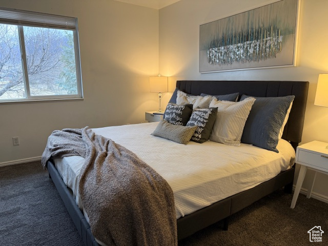 Carpeted bedroom with baseboards