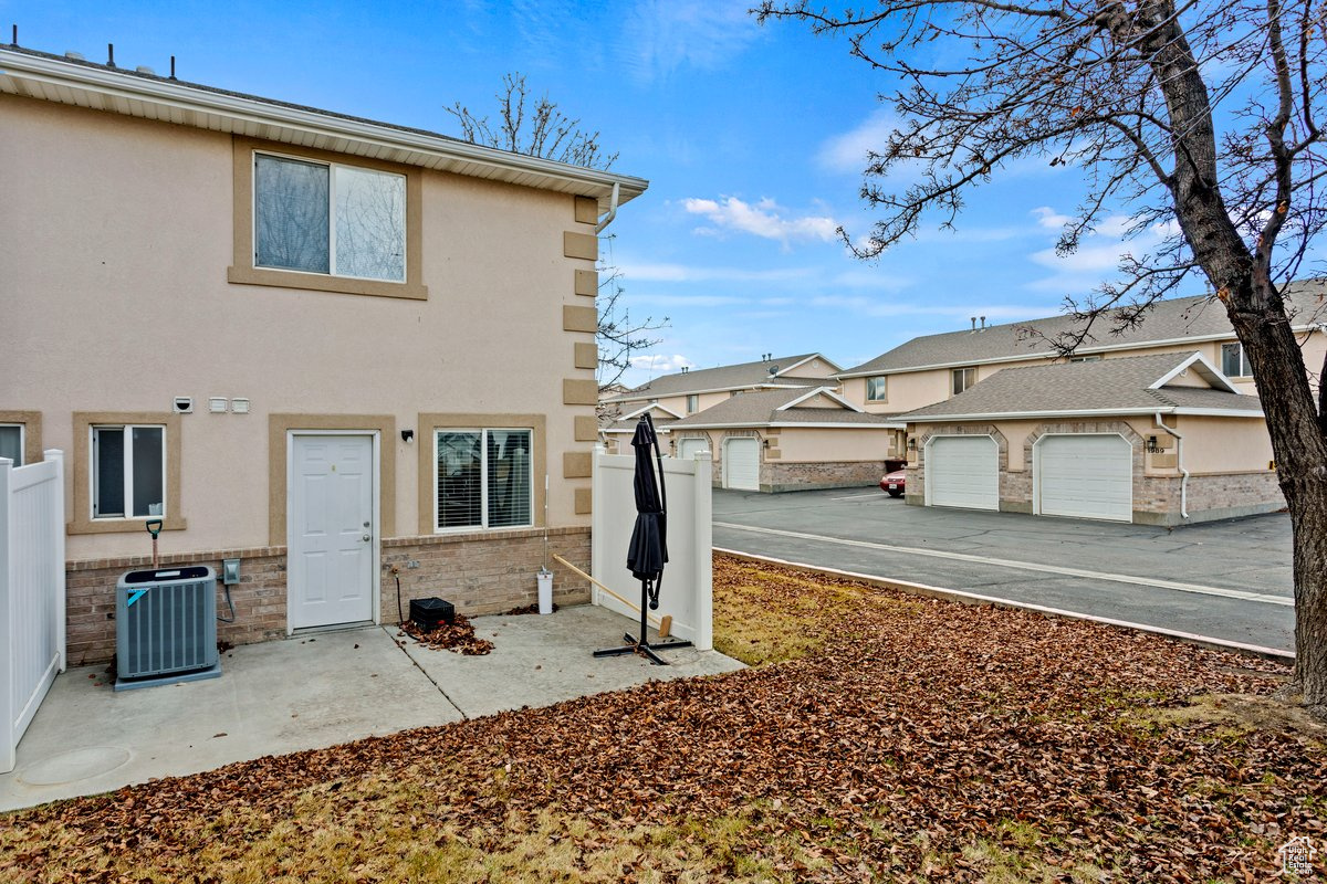 Rear view of house with a garage and central AC unit