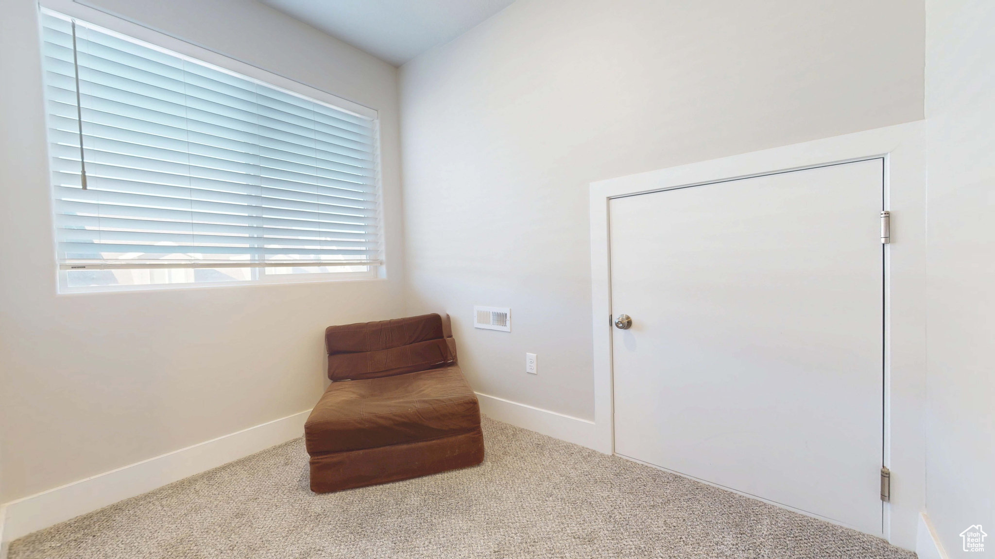 Sitting room featuring carpet floors