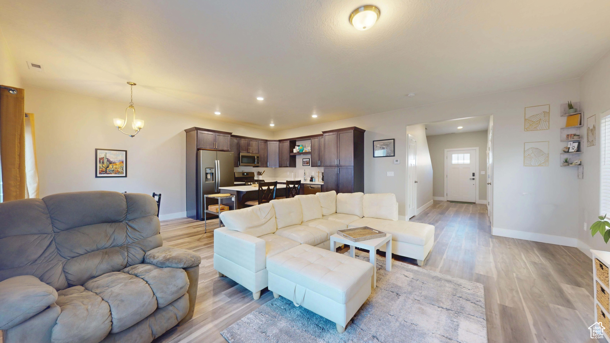 Living room with a chandelier and light hardwood / wood-style floors