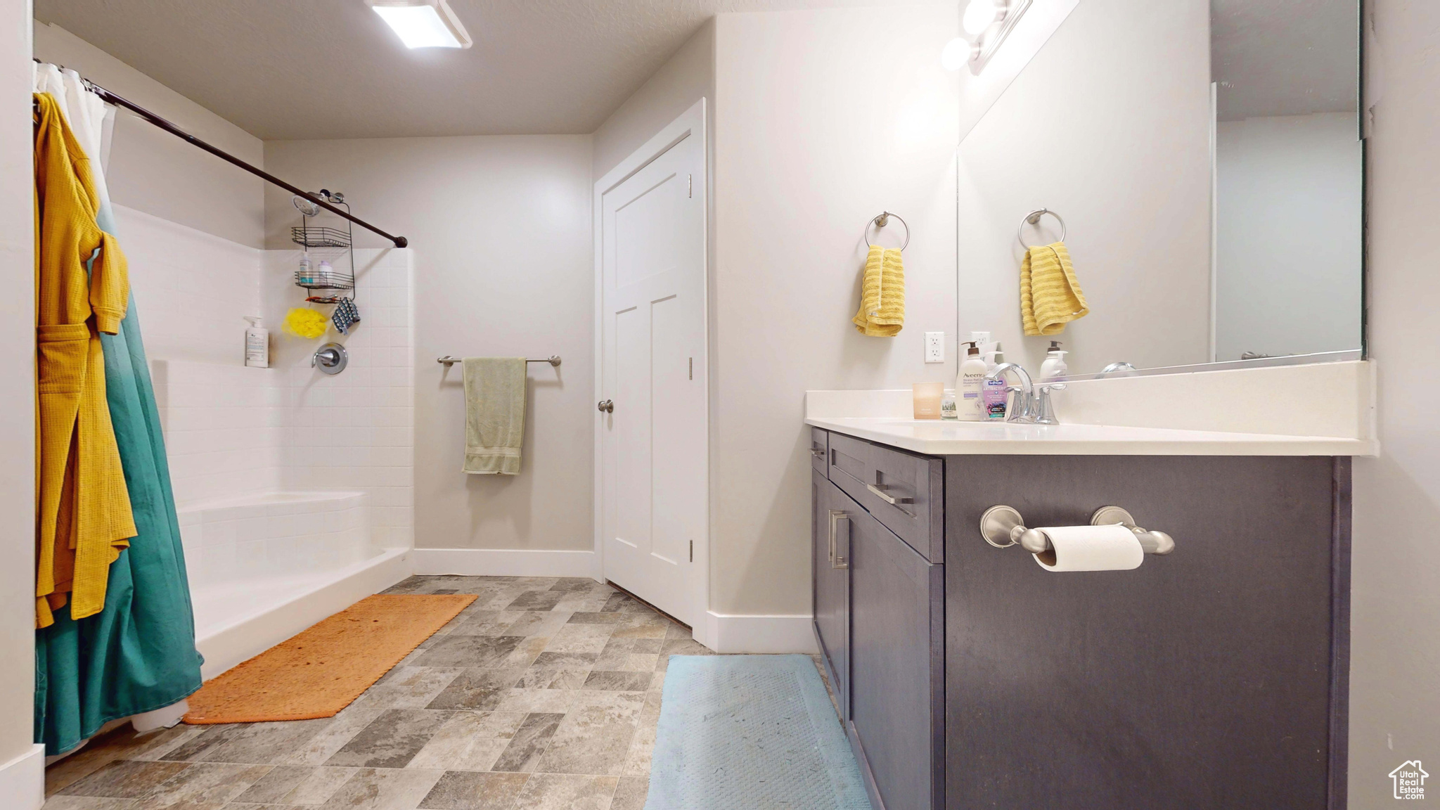 Bathroom featuring vanity and a shower