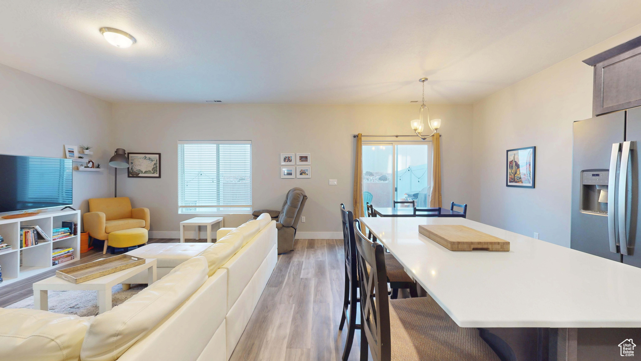 Interior space featuring an inviting chandelier, plenty of natural light, and light hardwood / wood-style floors
