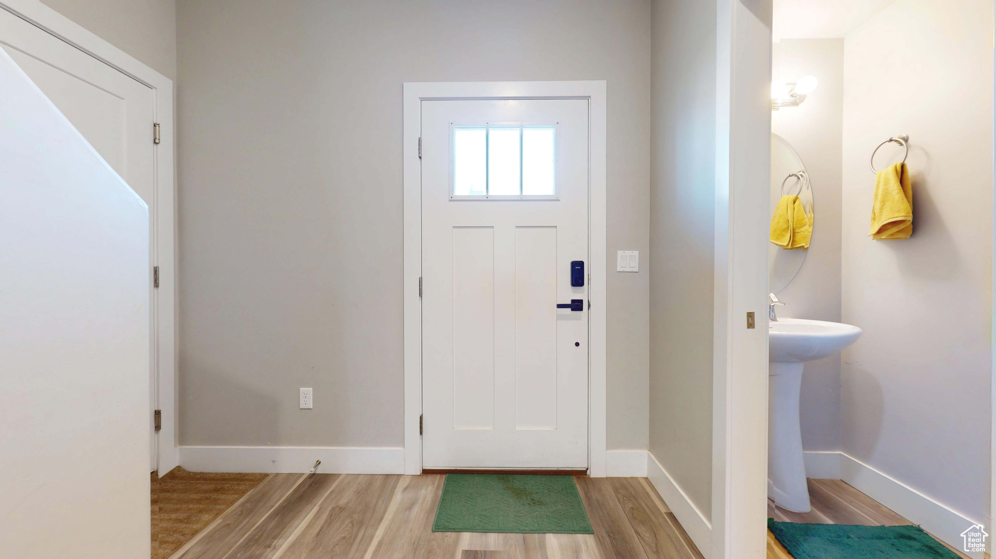 Entrance foyer with sink and light wood-type flooring