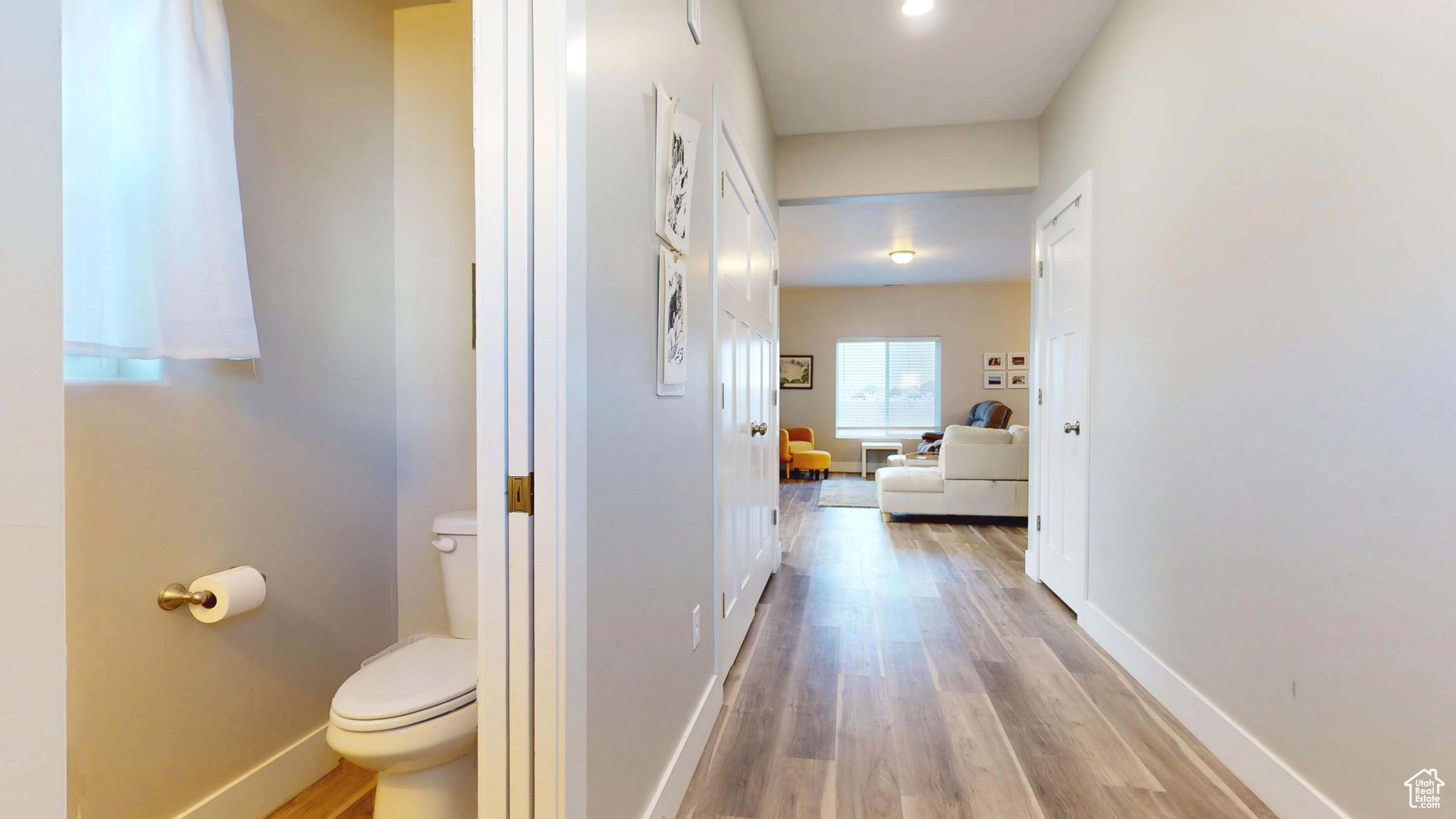 Hallway with light hardwood / wood-style flooring