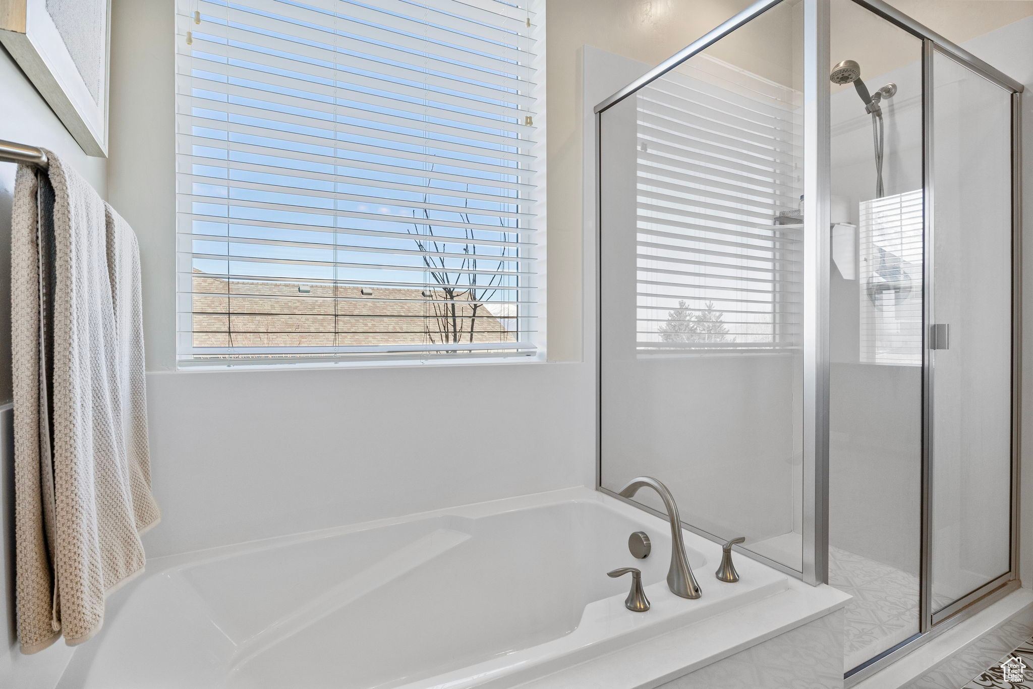 Bathroom with a stall shower and a garden tub