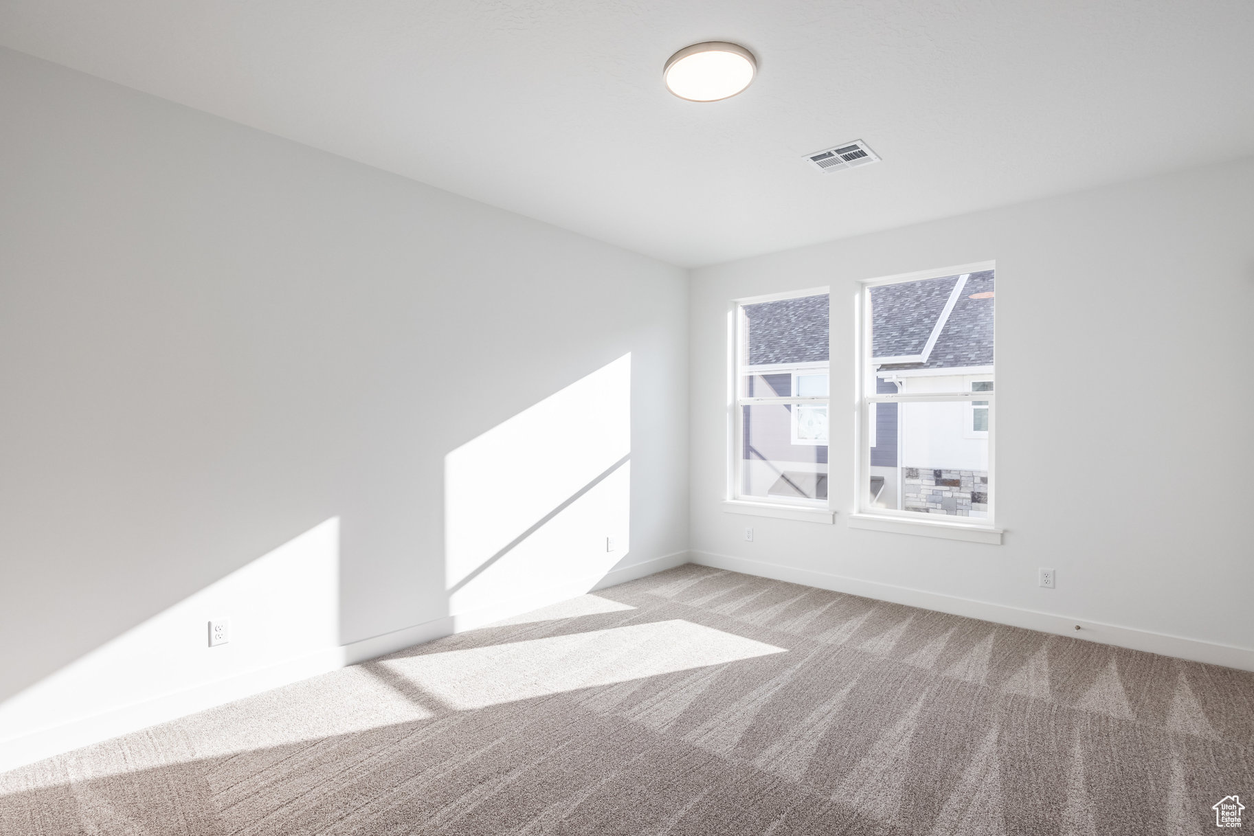 Unfurnished room with light colored carpet