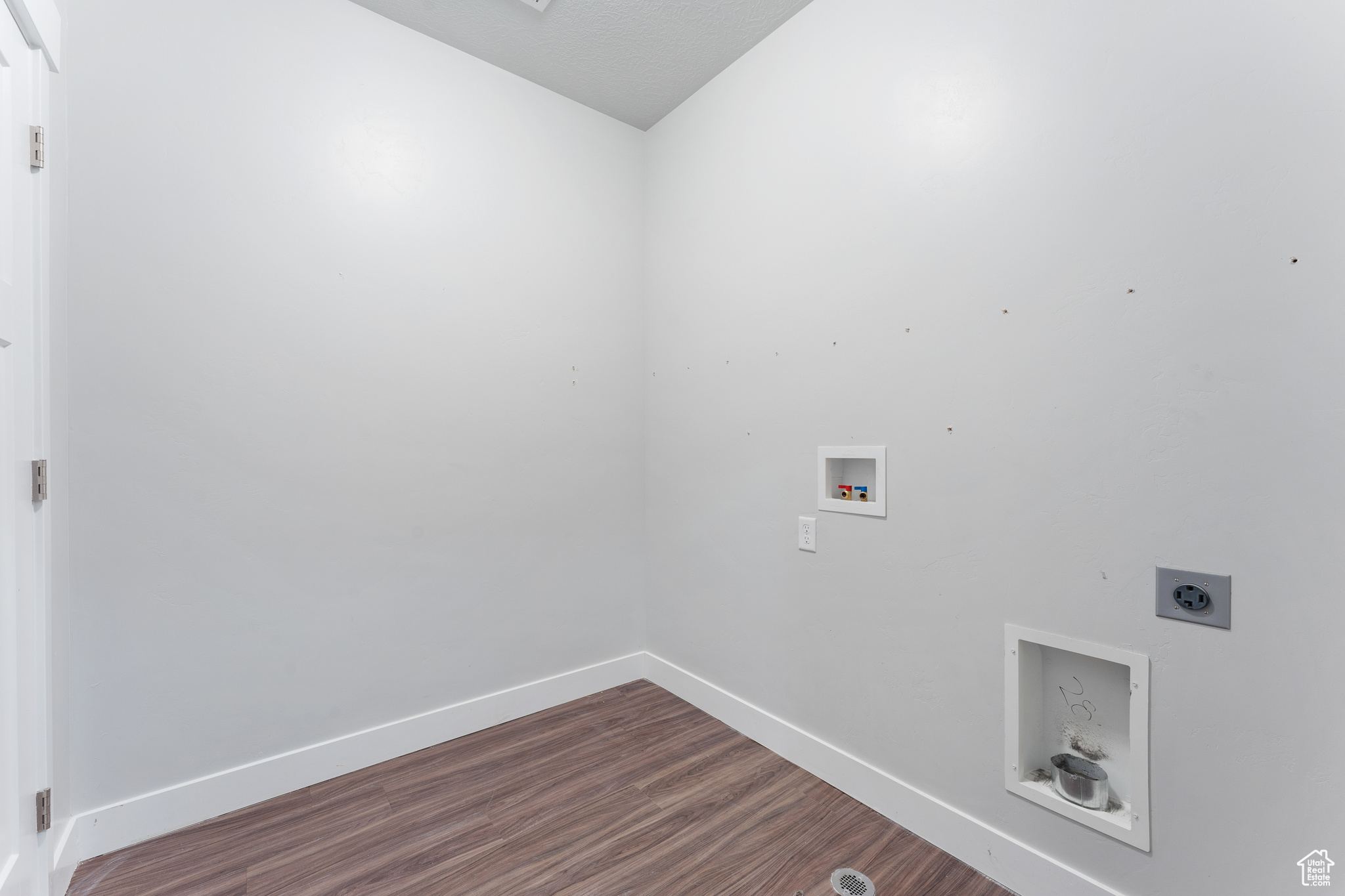 Laundry room featuring hardwood / wood-style flooring, electric dryer hookup, and washer hookup