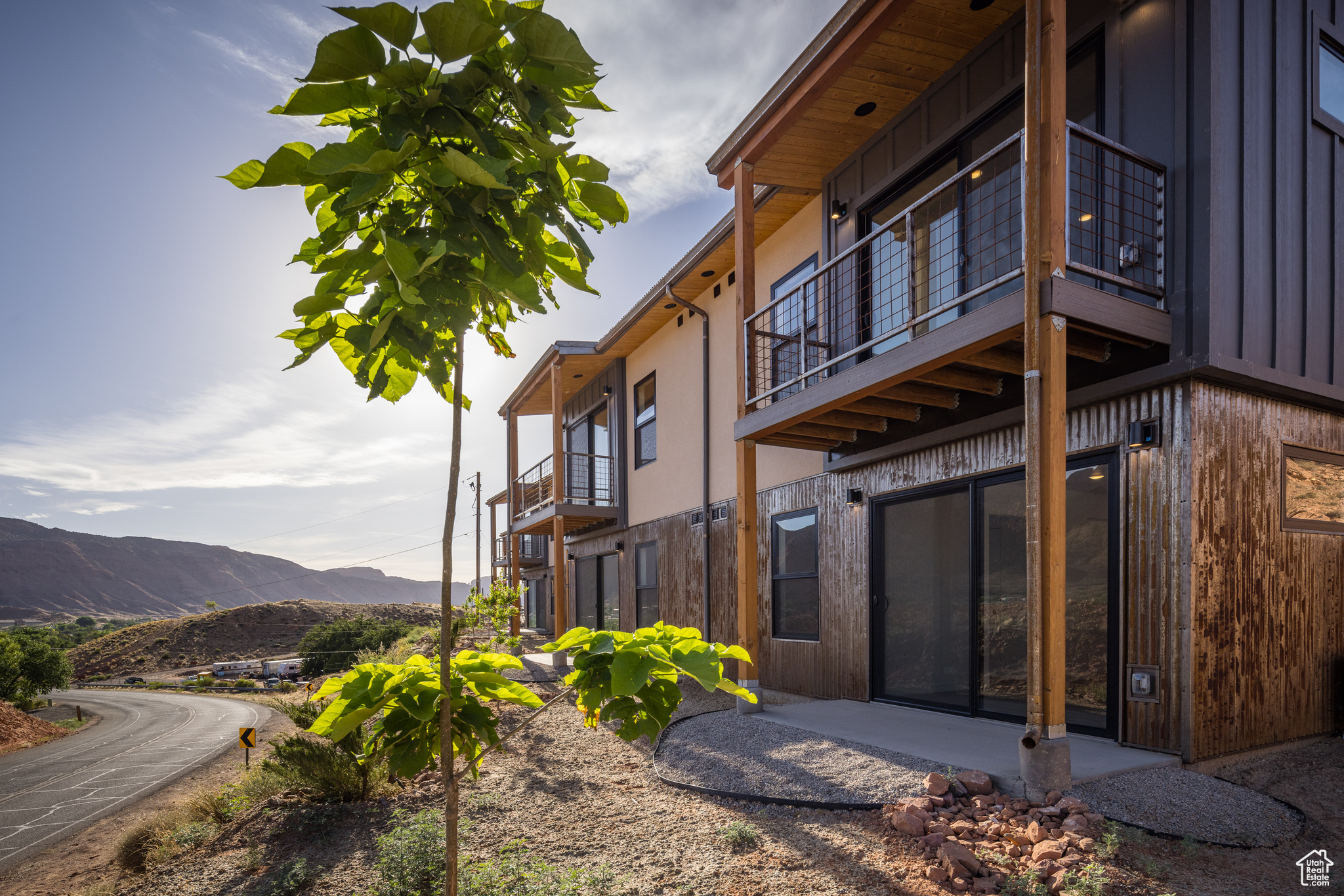 View of home's exterior featuring a balcony and a mountain view