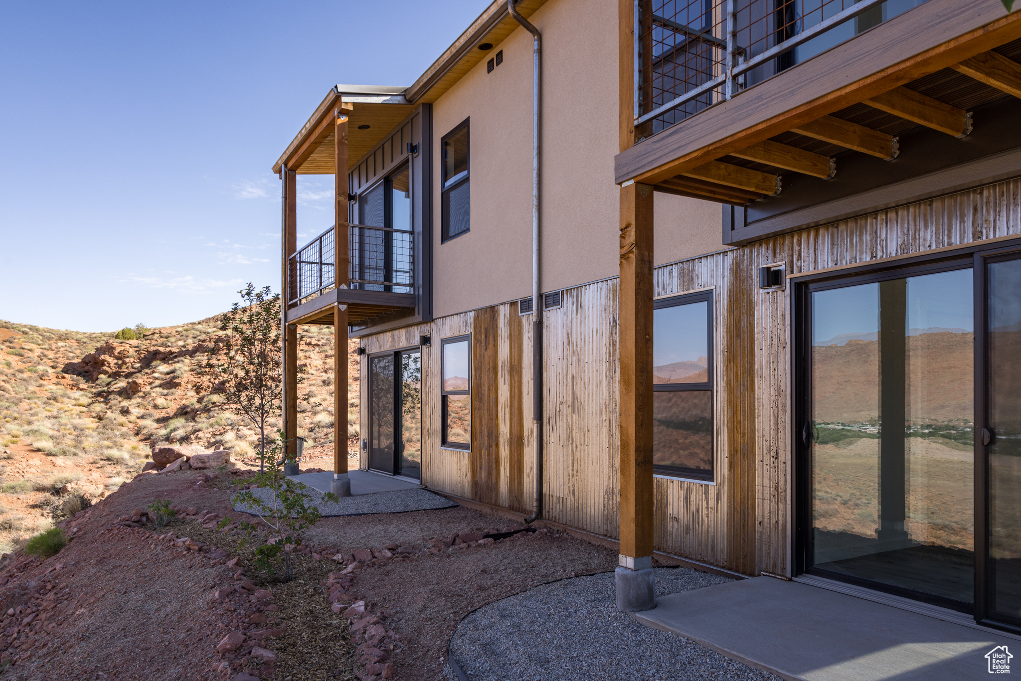 View of side of property with a balcony