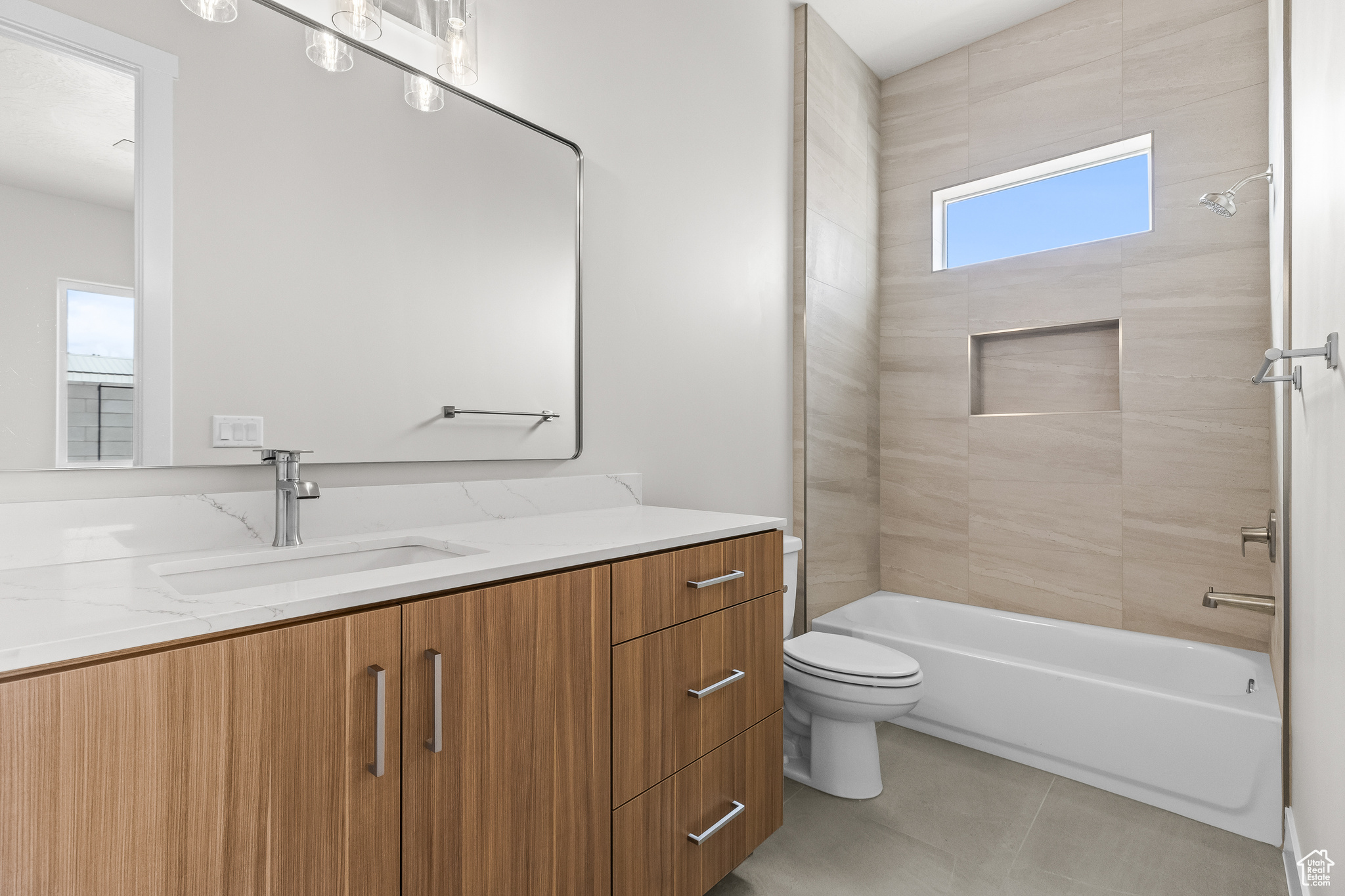 Full bathroom featuring shower / bath combination, tile patterned flooring, toilet, and vanity