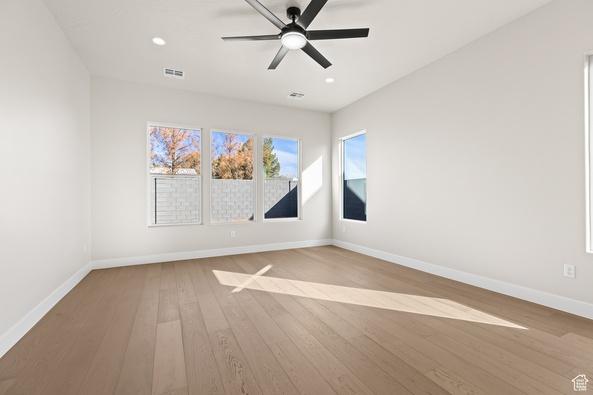 Spare room featuring recessed lighting, baseboards, ceiling fan, and hardwood / wood-style flooring