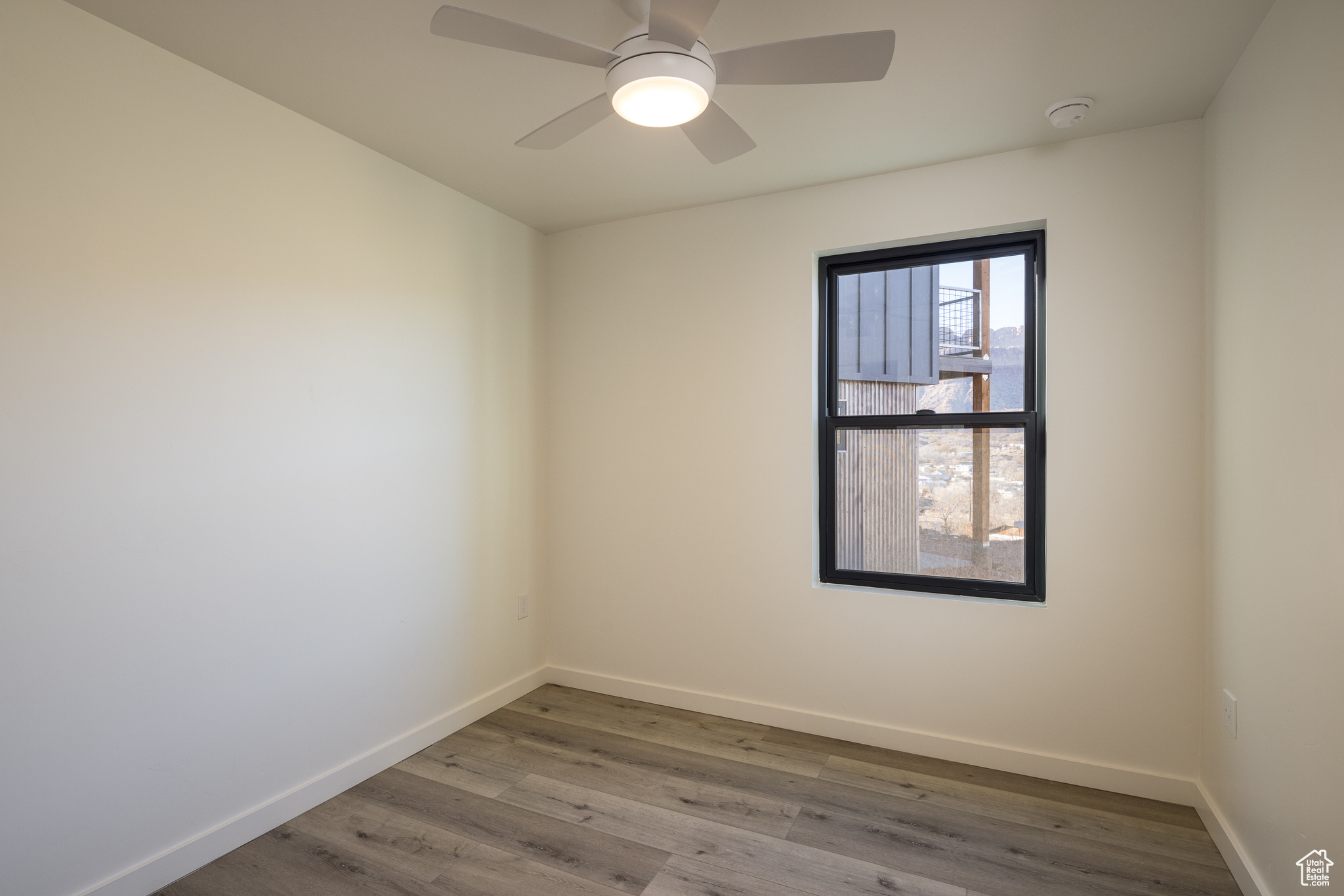 Spare room featuring ceiling fan and wood-type flooring