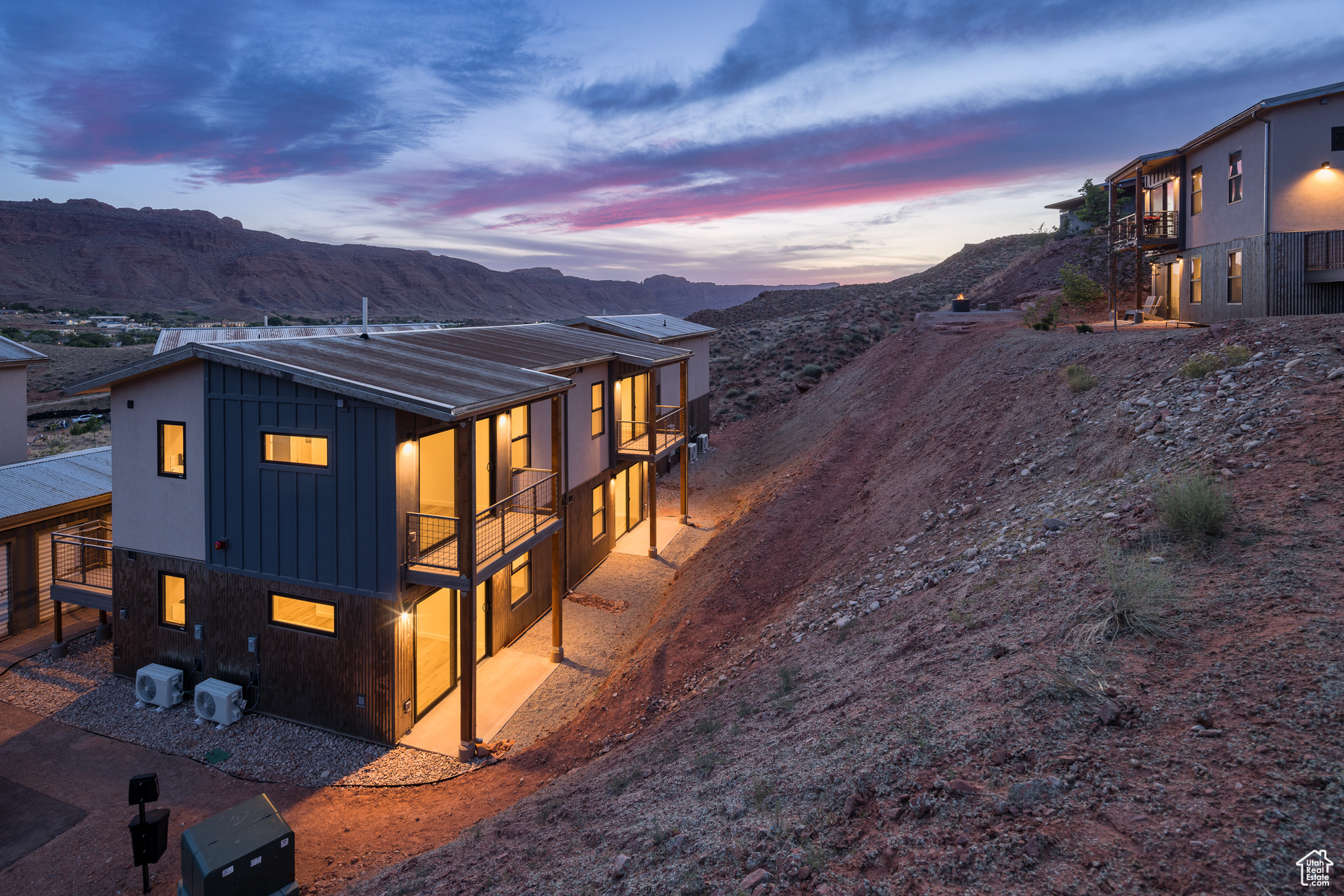 Property exterior at dusk with a balcony and a mountain view