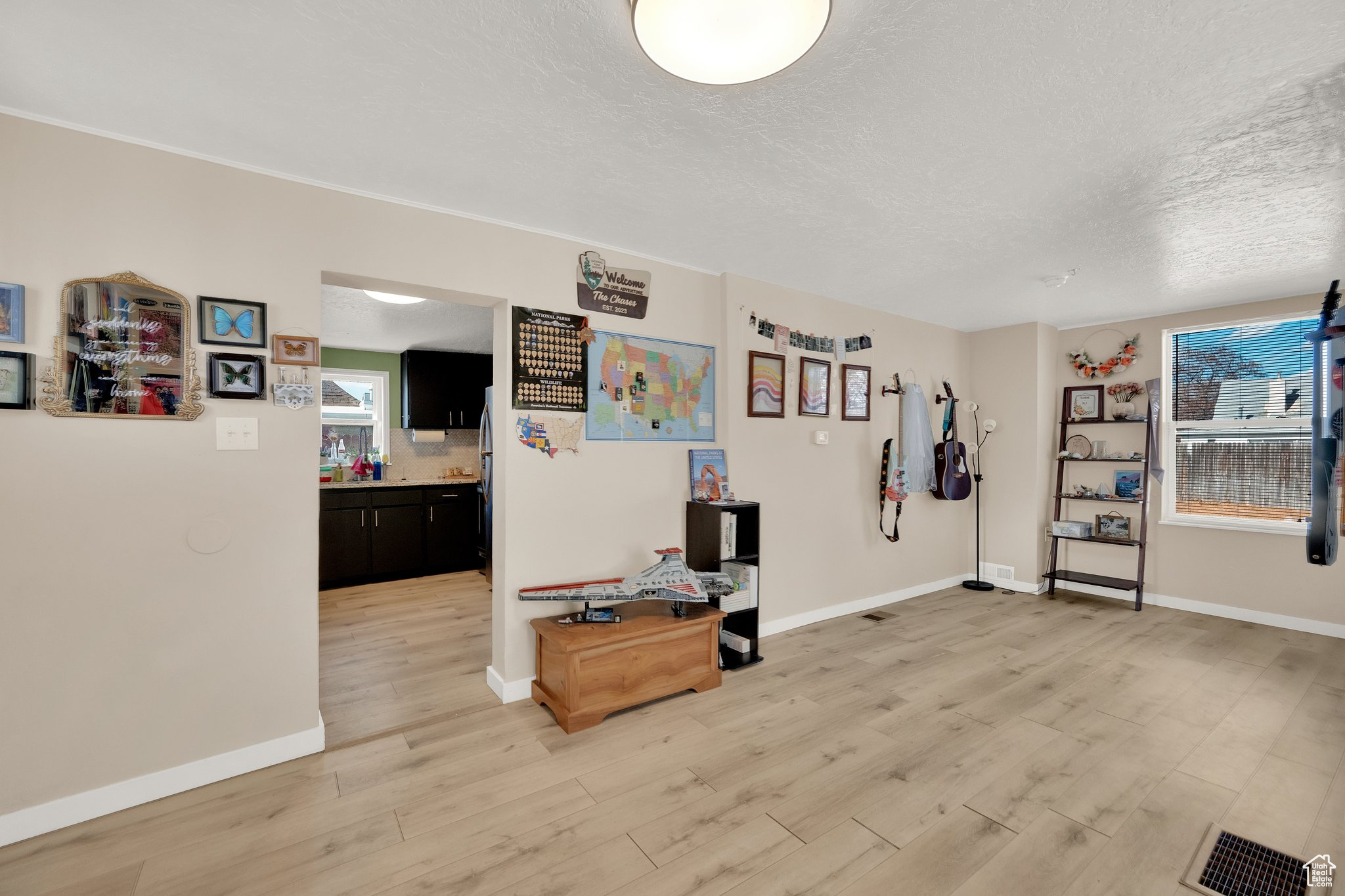 Interior space with a textured ceiling and light wood-type flooring
