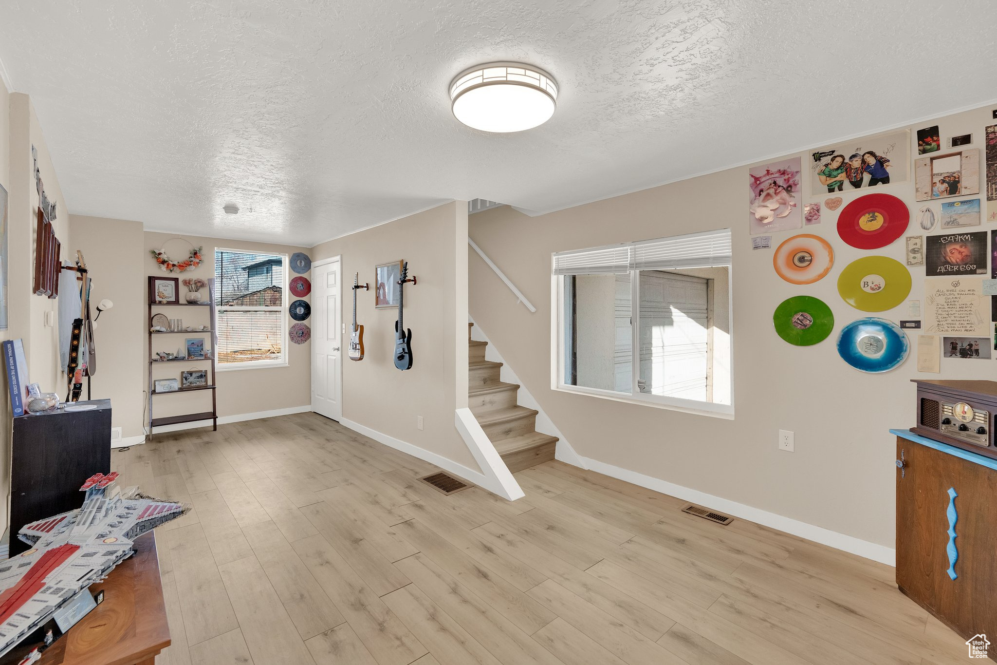 Entrance foyer with light hardwood / wood-style flooring and a textured ceiling