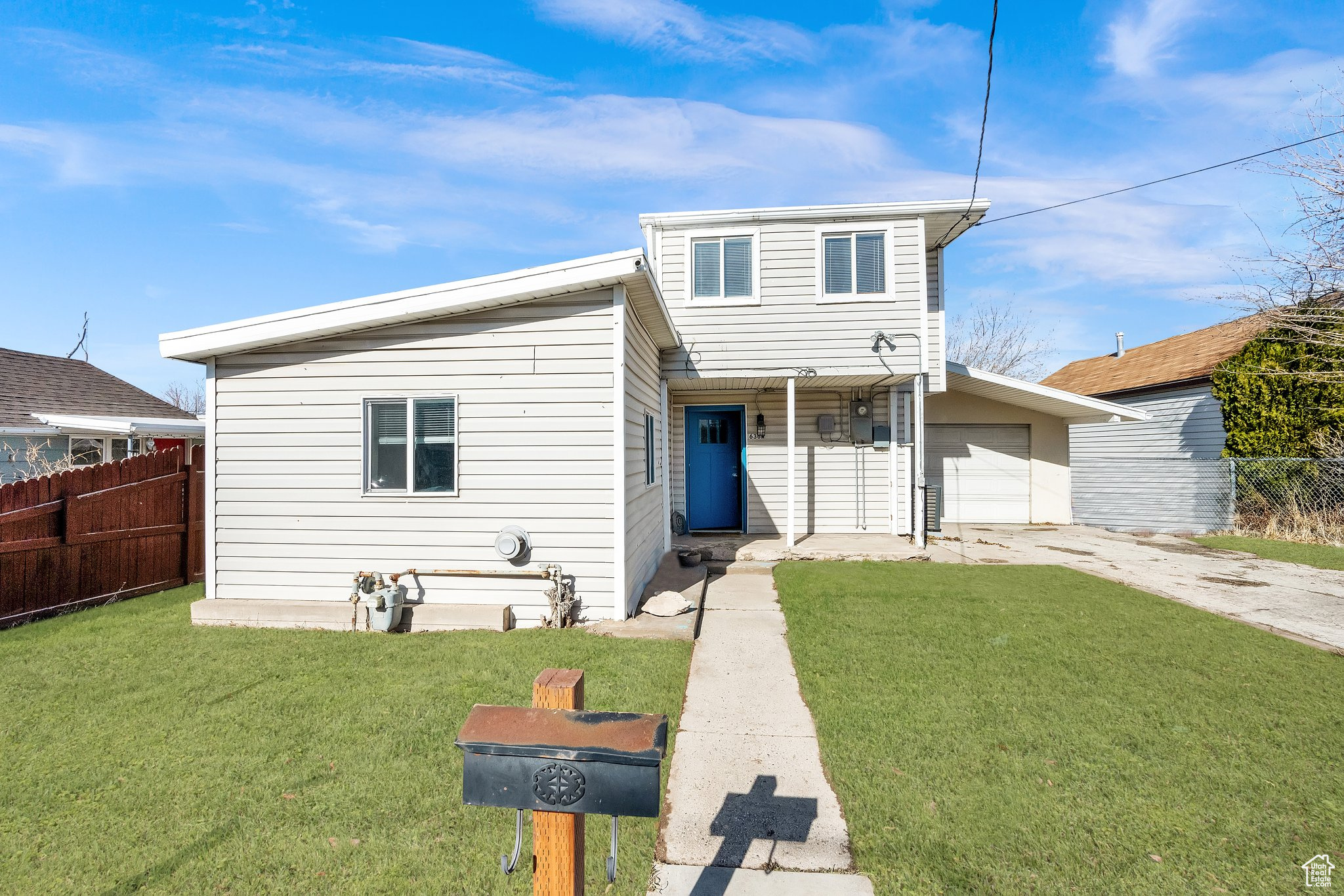 View of front of property with a garage and a front yard (Green Grass rendered to show possibilities)
