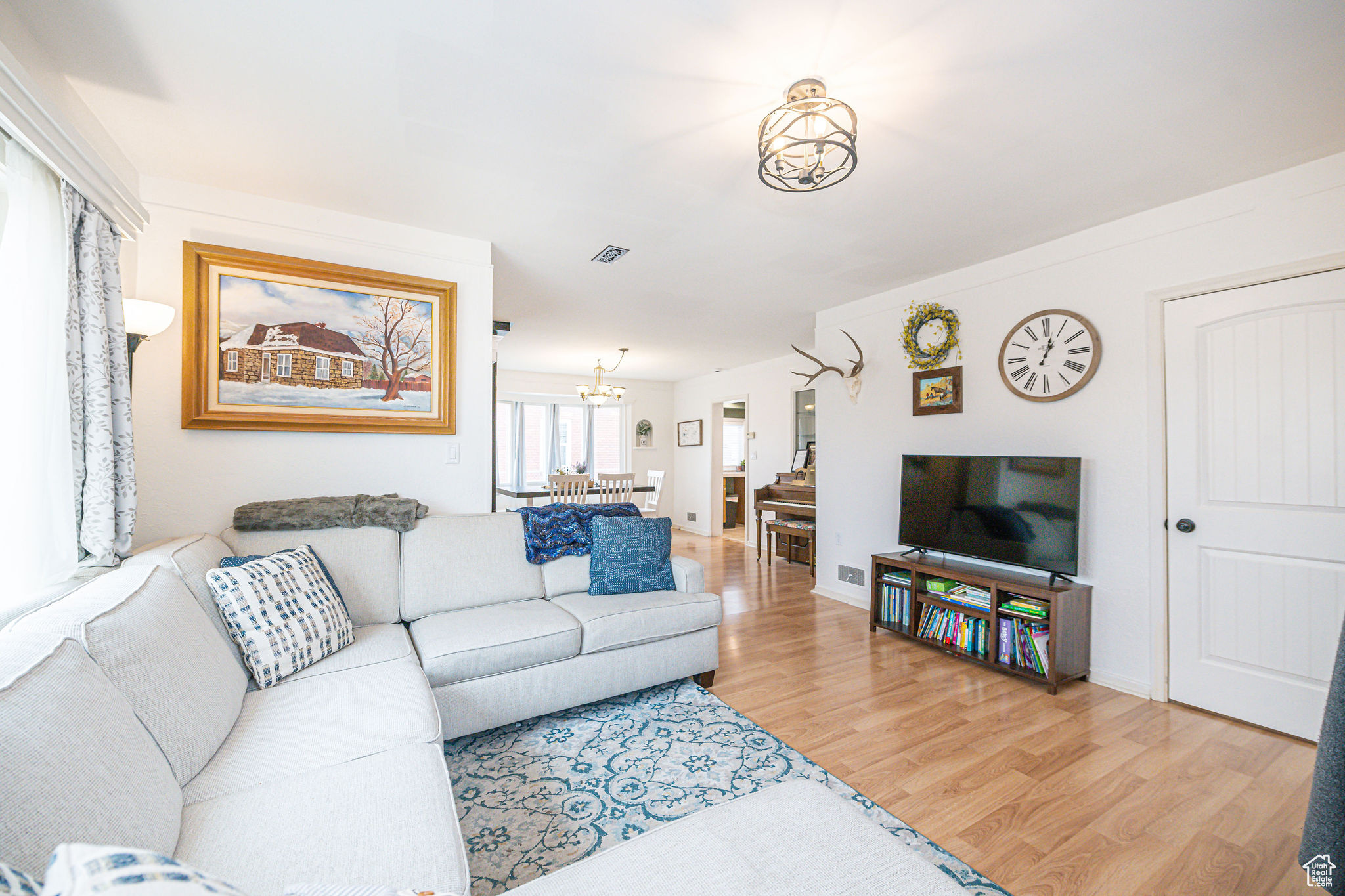 Living room with an inviting chandelier and hardwood / wood-style floors