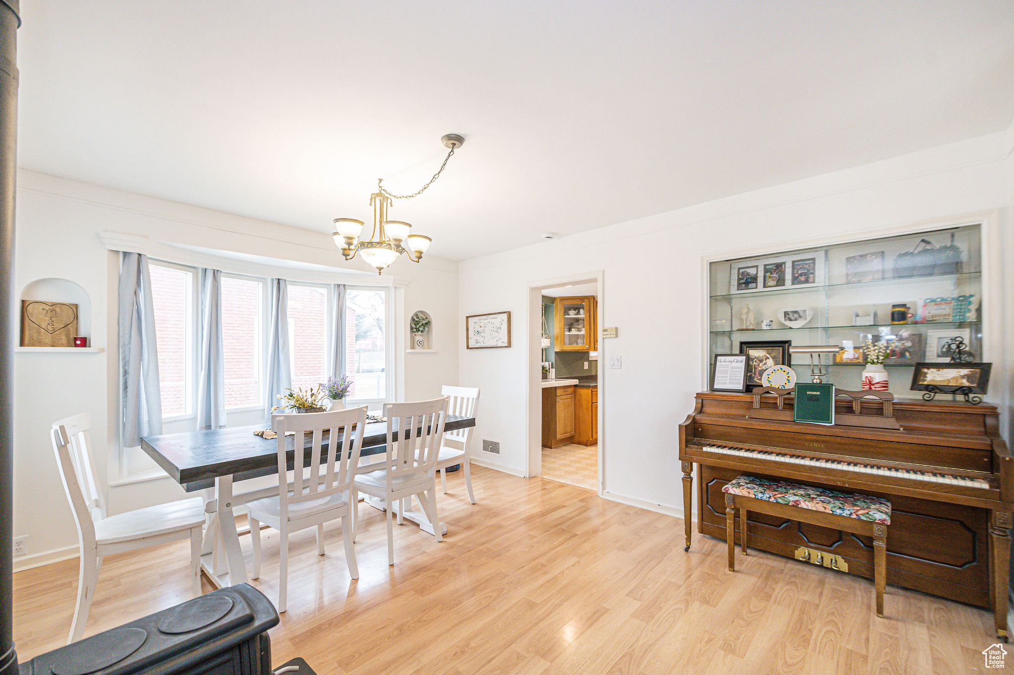 Dining space with light hardwood / wood-style flooring and a notable chandelier