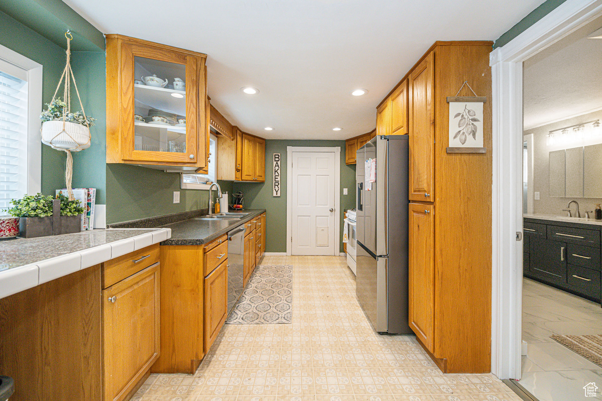 Kitchen featuring sink, stainless steel appliances, and hanging light fixtures