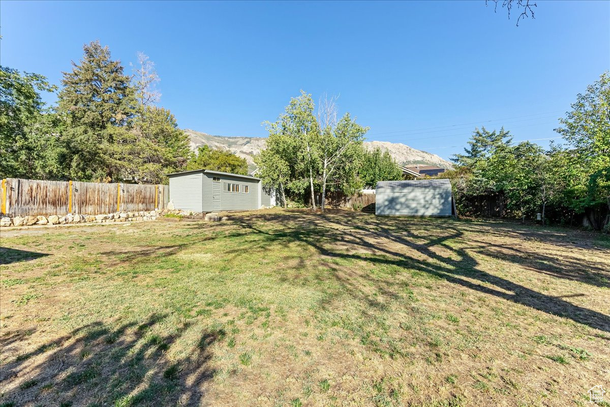 View of yard with a shed and a mountain view