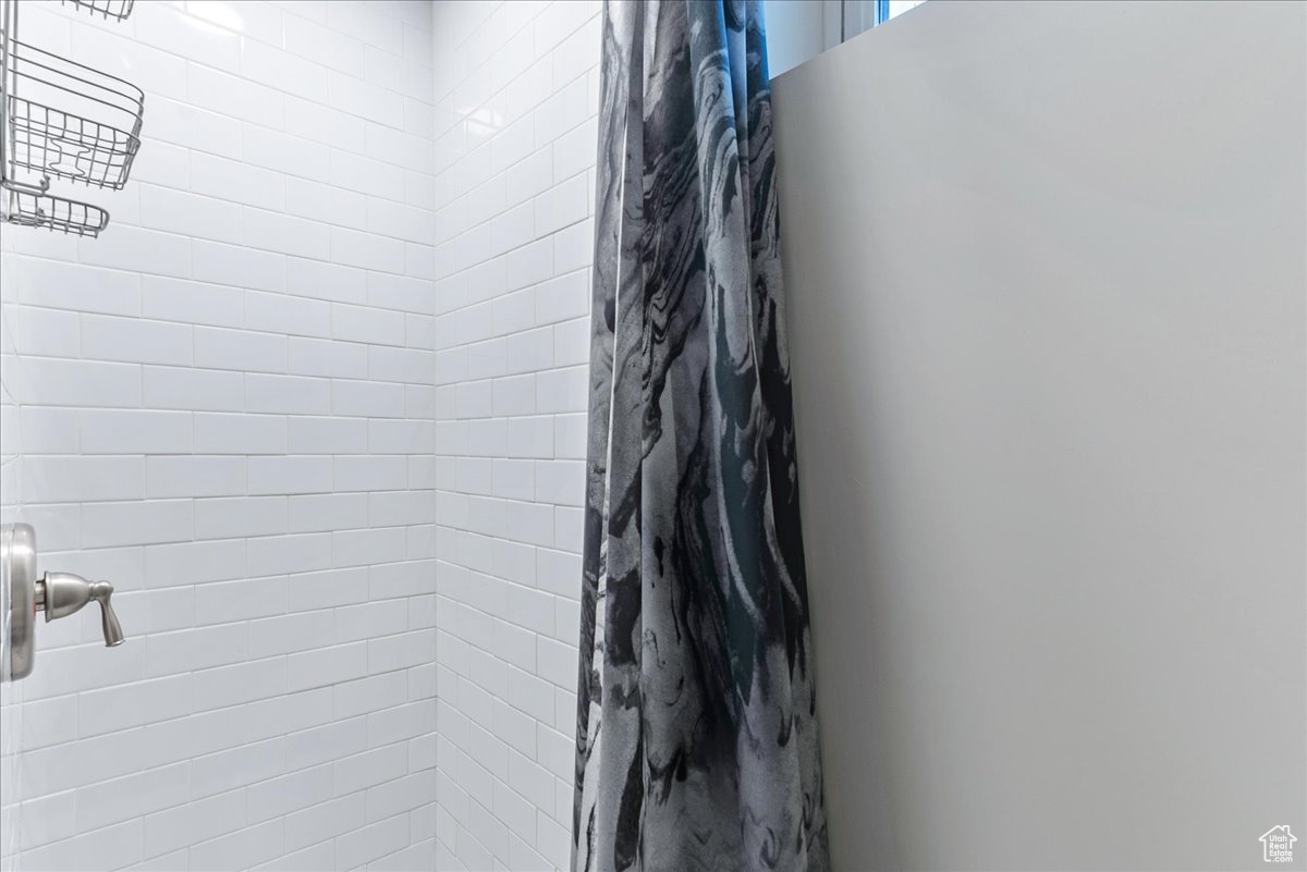 Bathroom featuring a shower with shower curtain