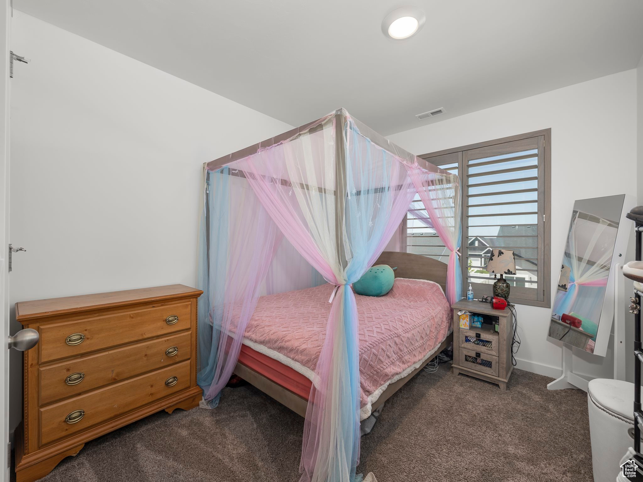 Bedroom featuring dark carpet