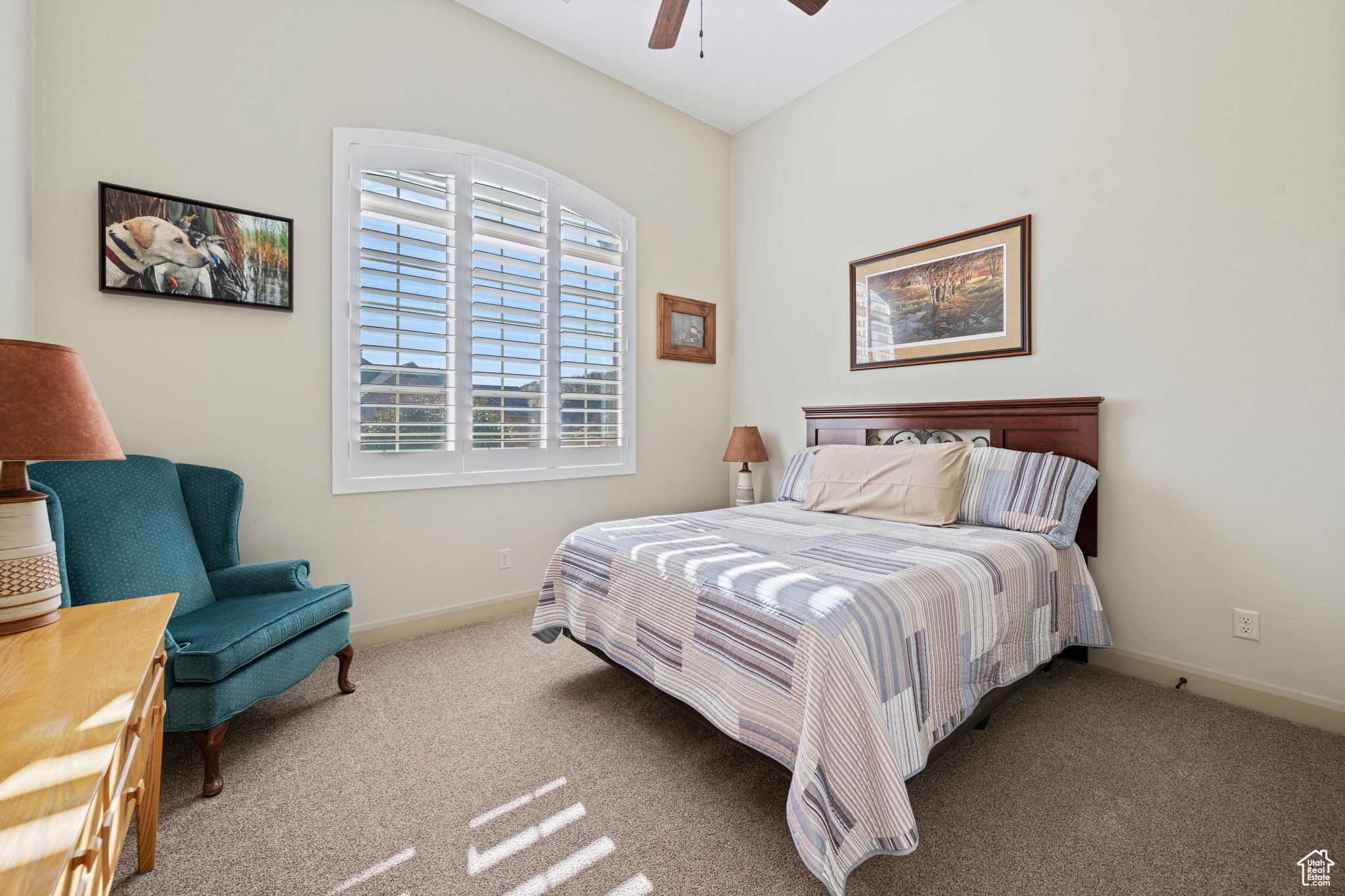 Carpeted bedroom with ceiling fan