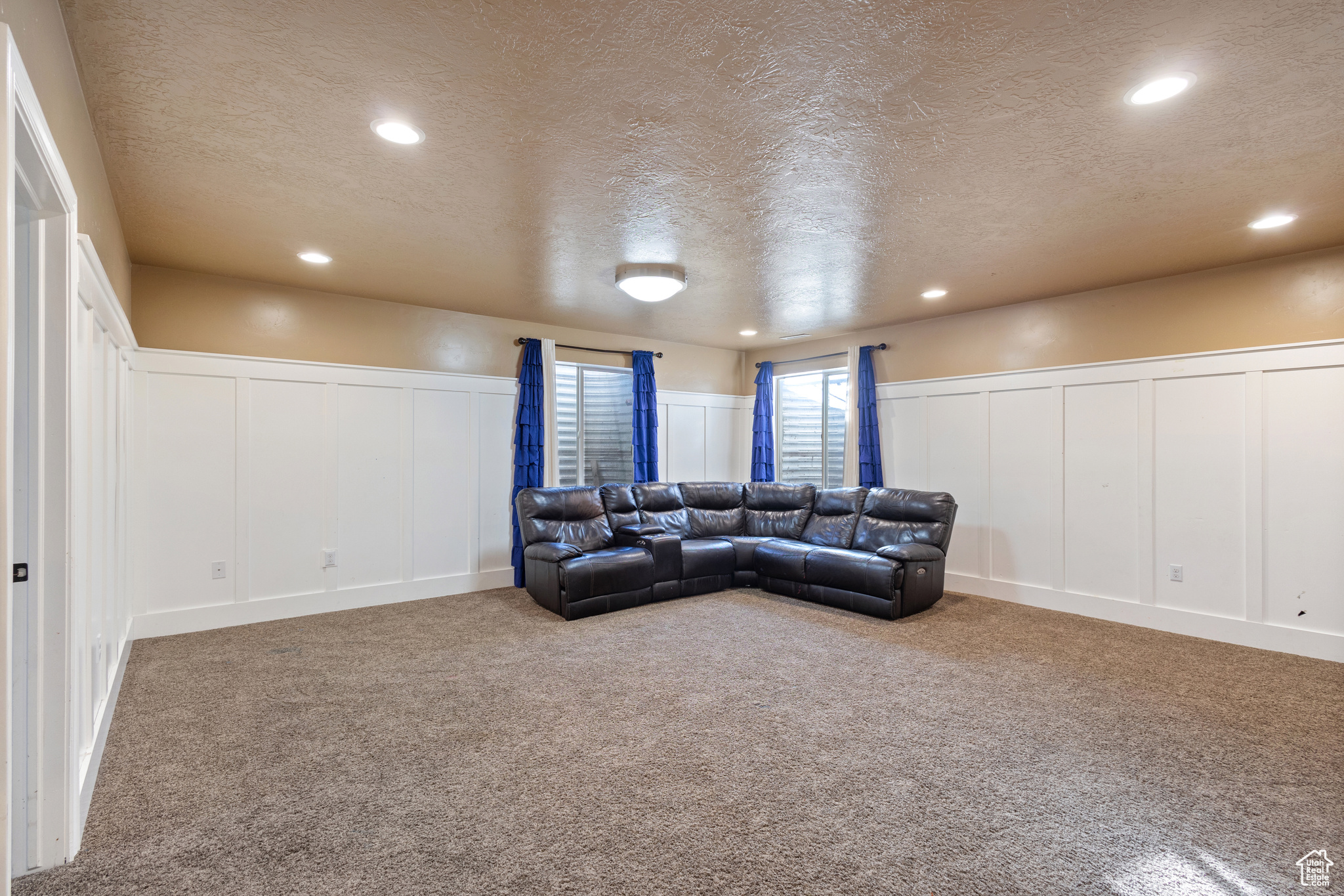 Living room featuring a textured ceiling and carpet