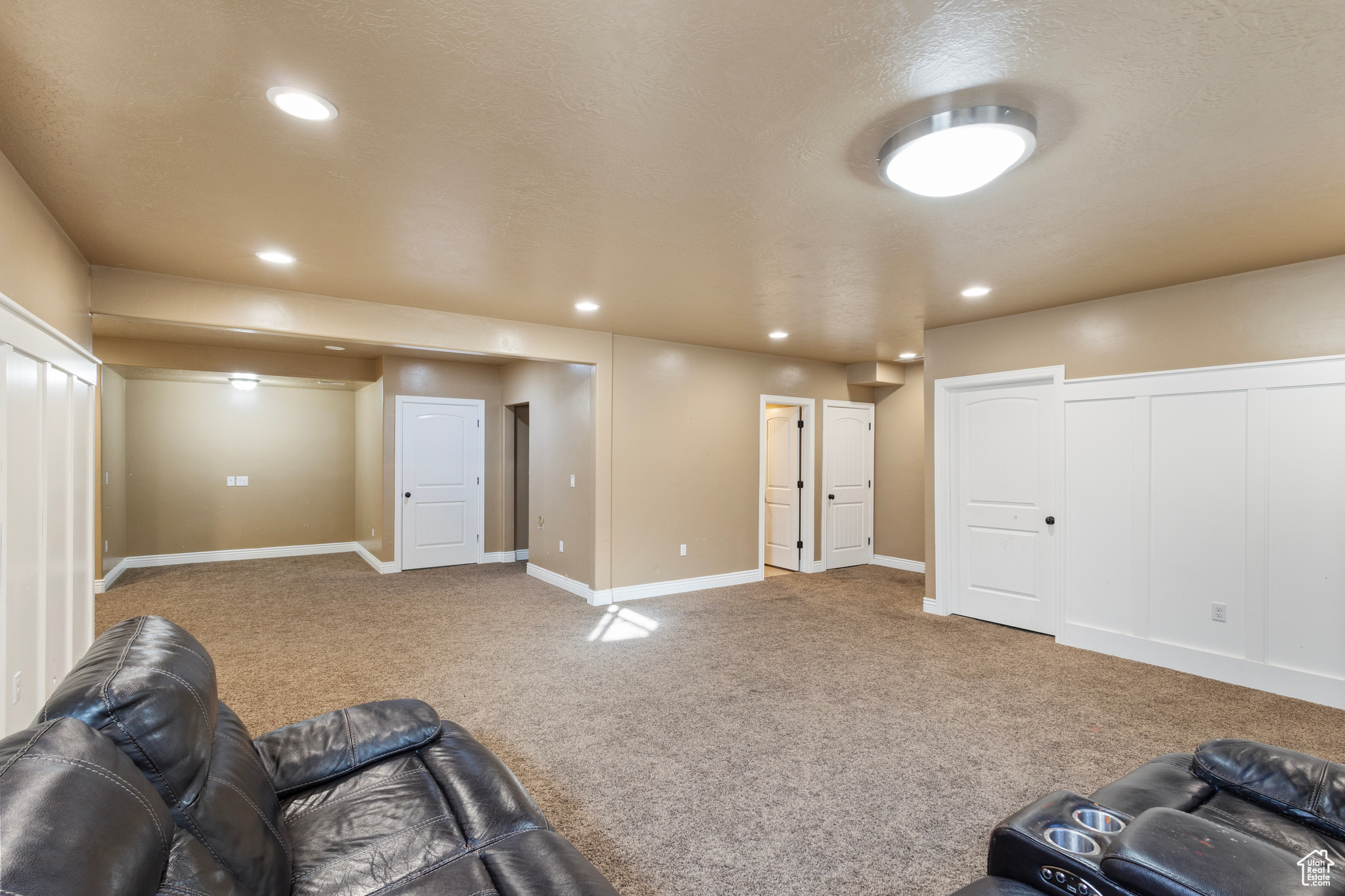 Living room with carpet and a textured ceiling