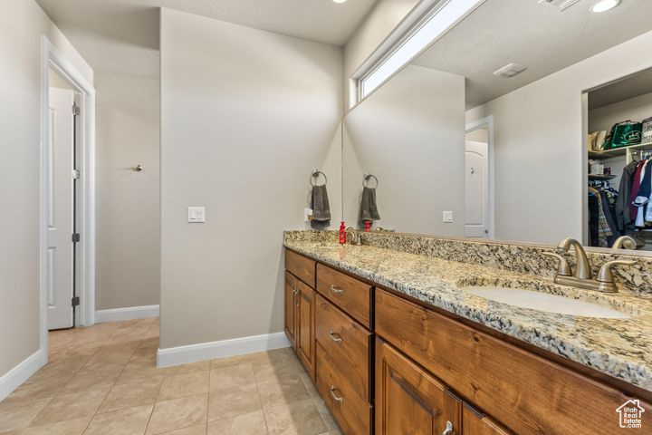 Bathroom featuring tile patterned flooring and vanity