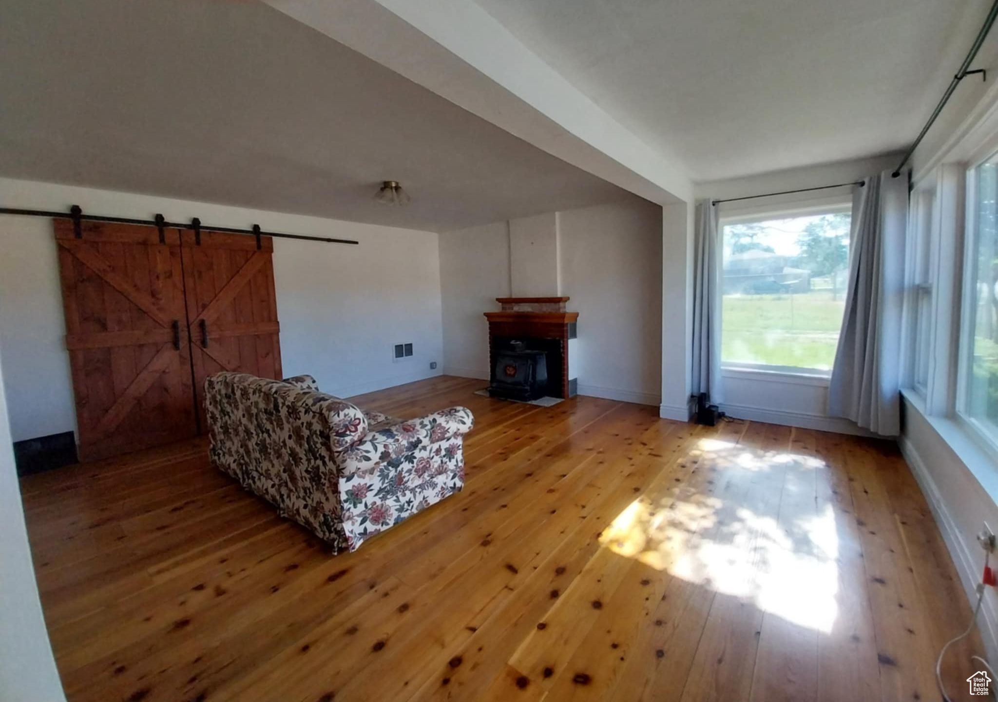 Living room with hardwood / wood-style flooring and a barn door
