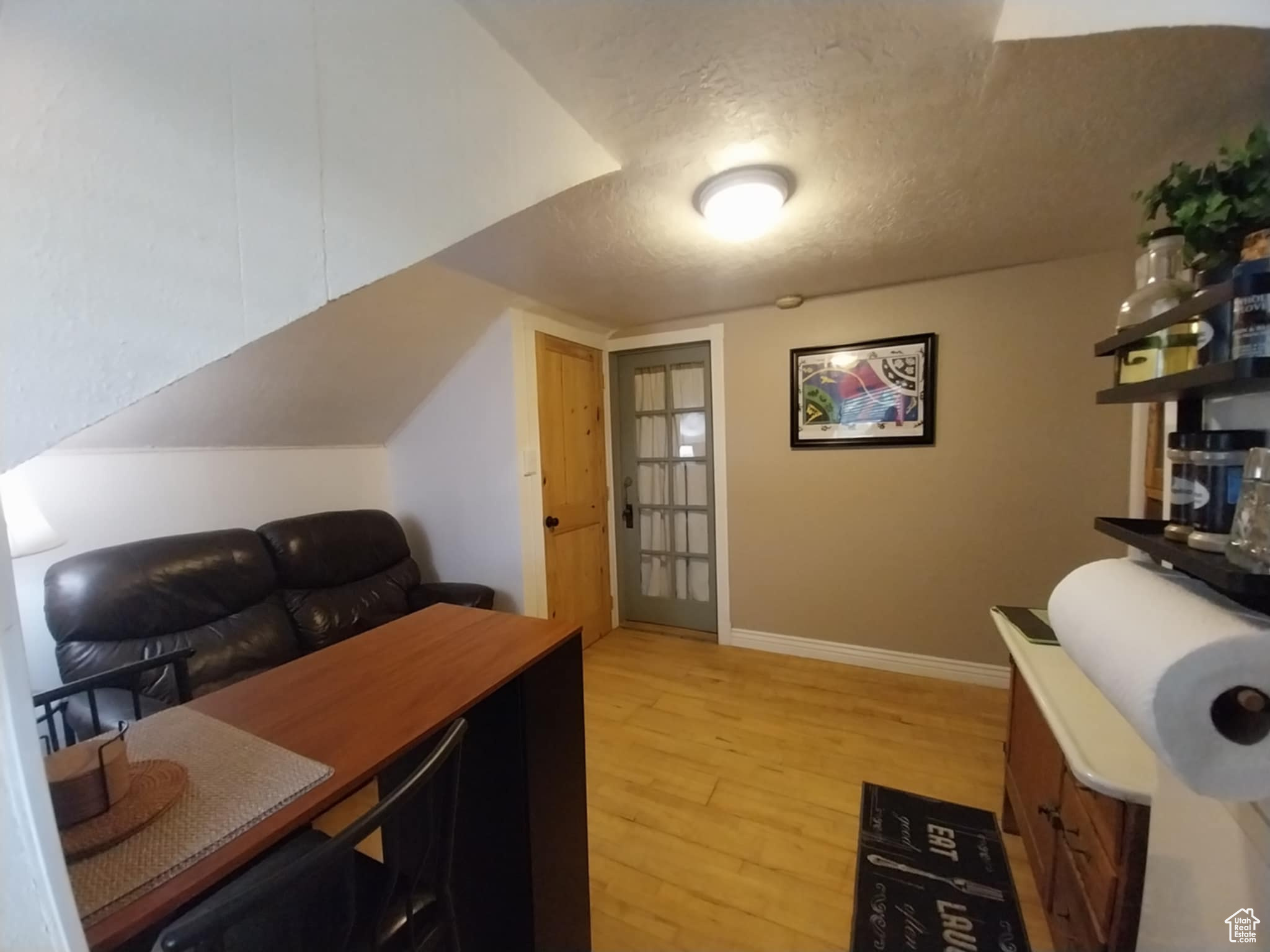 Office area featuring a textured ceiling and light hardwood / wood-style flooring