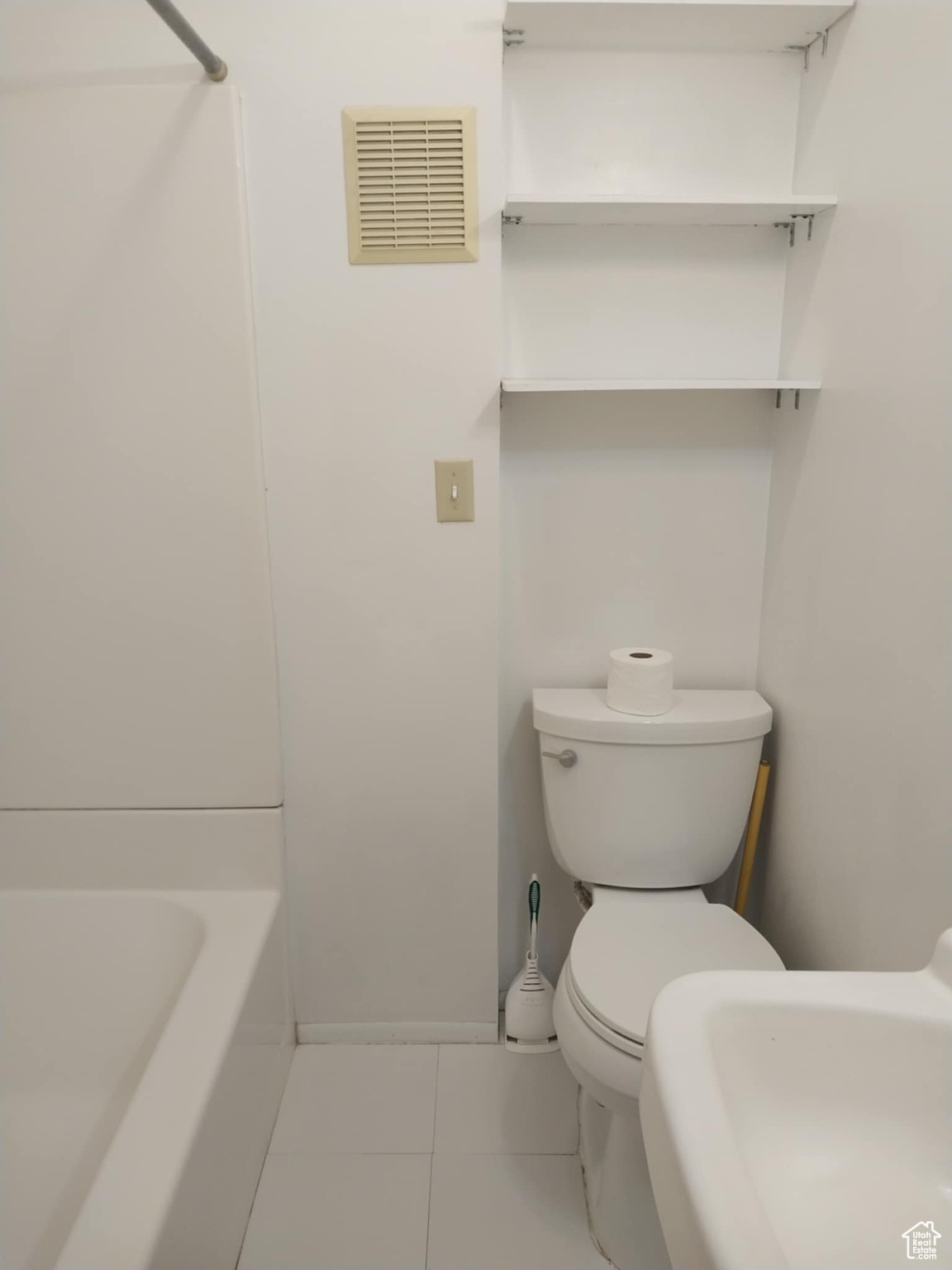 Bathroom featuring sink, a bathtub, tile patterned floors, and toilet