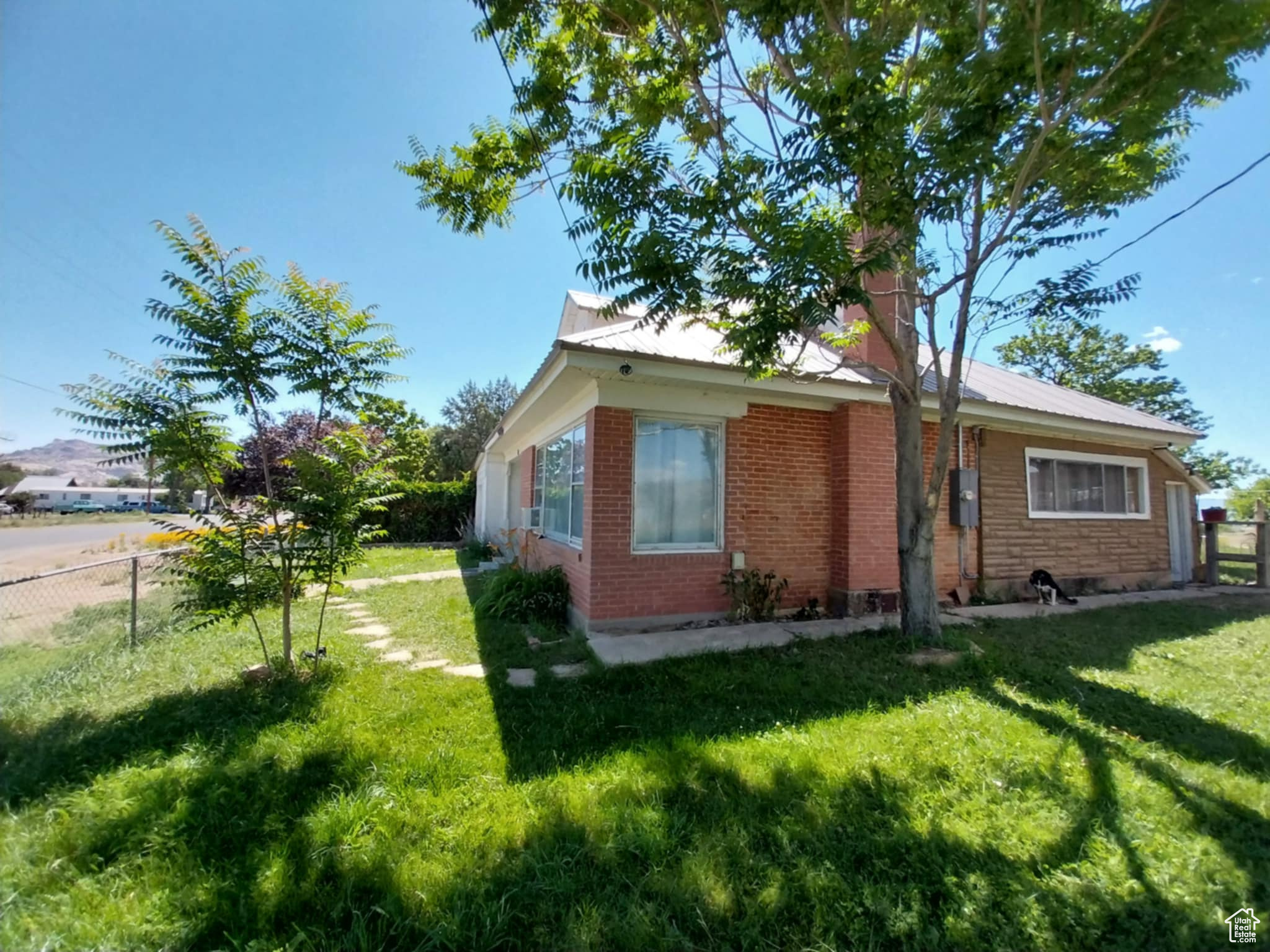 View of side of property featuring a lawn