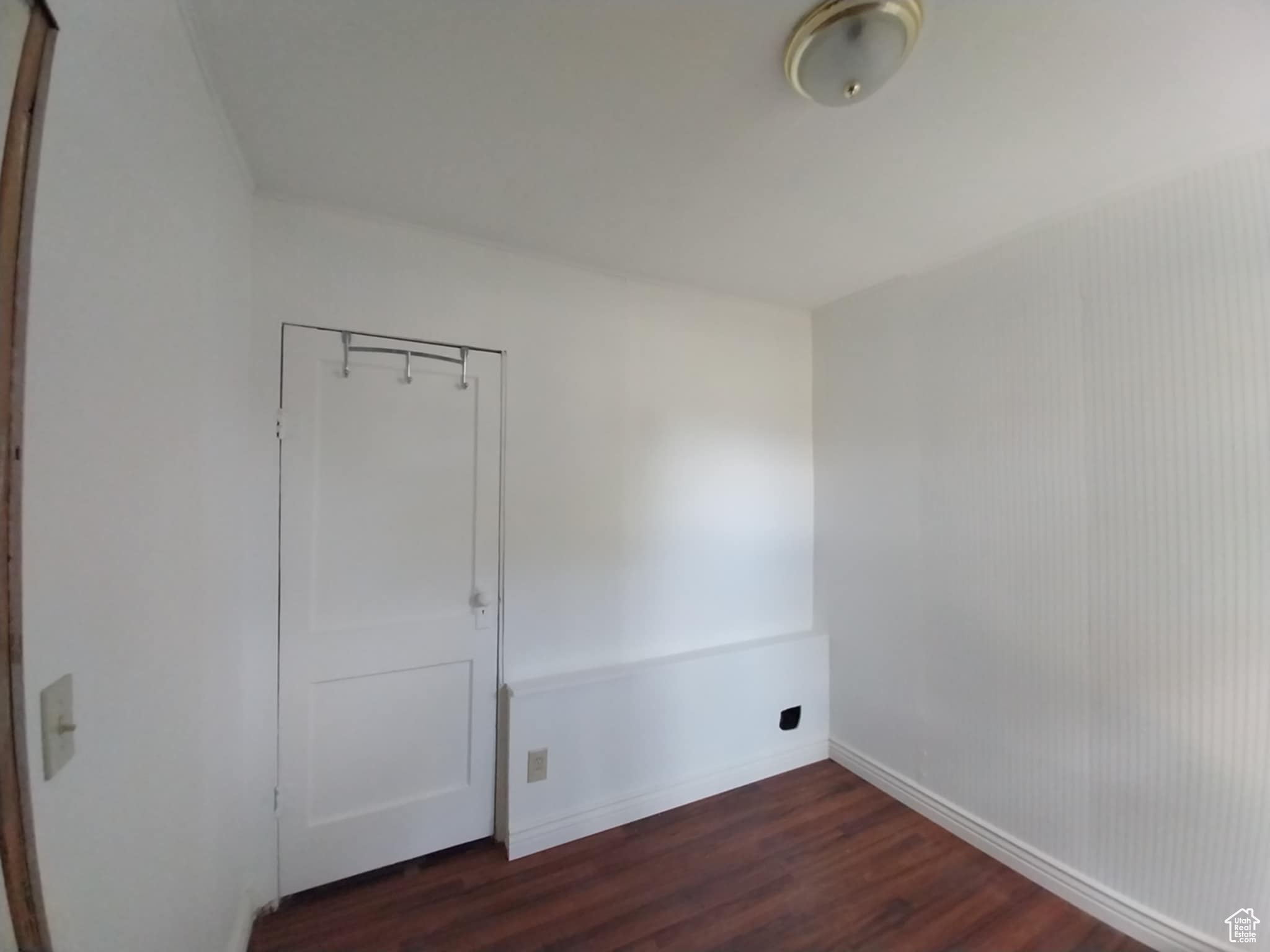 Spare room with dark wood-type flooring