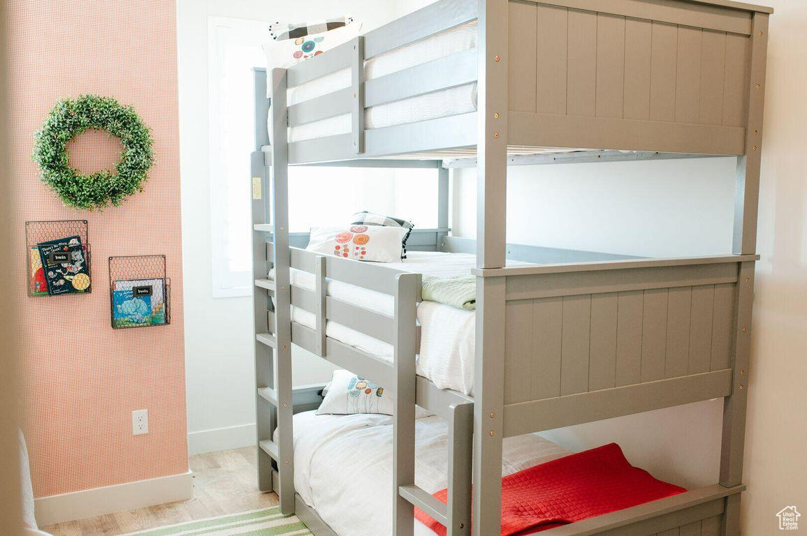Bedroom with light hardwood / wood-style flooring