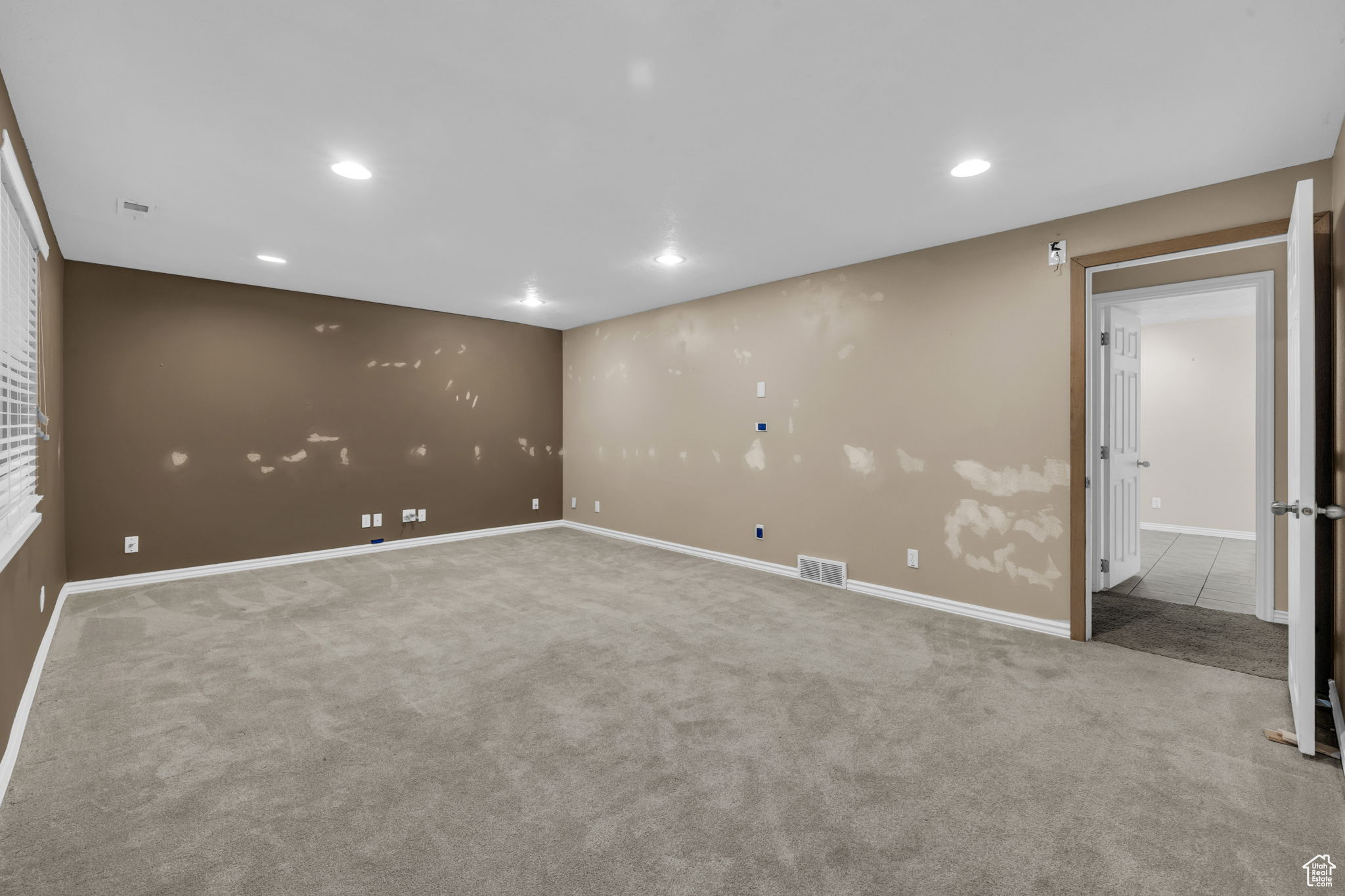 Unfurnished room featuring light colored carpet