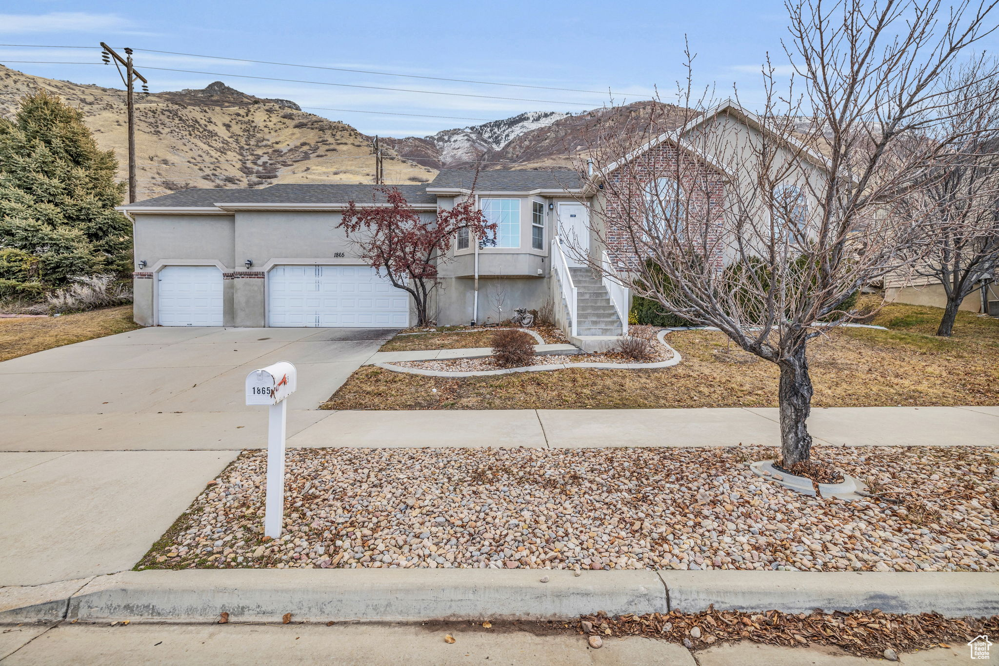 View of front of home with a garage and a mountain view