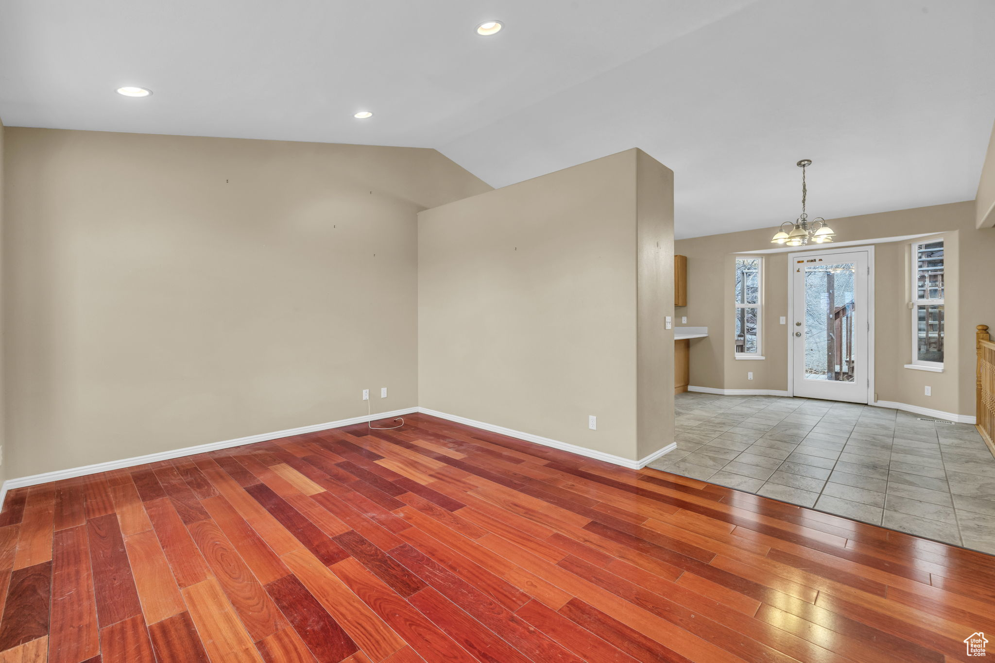 Interior space featuring an inviting chandelier, hardwood / wood-style floors, and lofted ceiling
