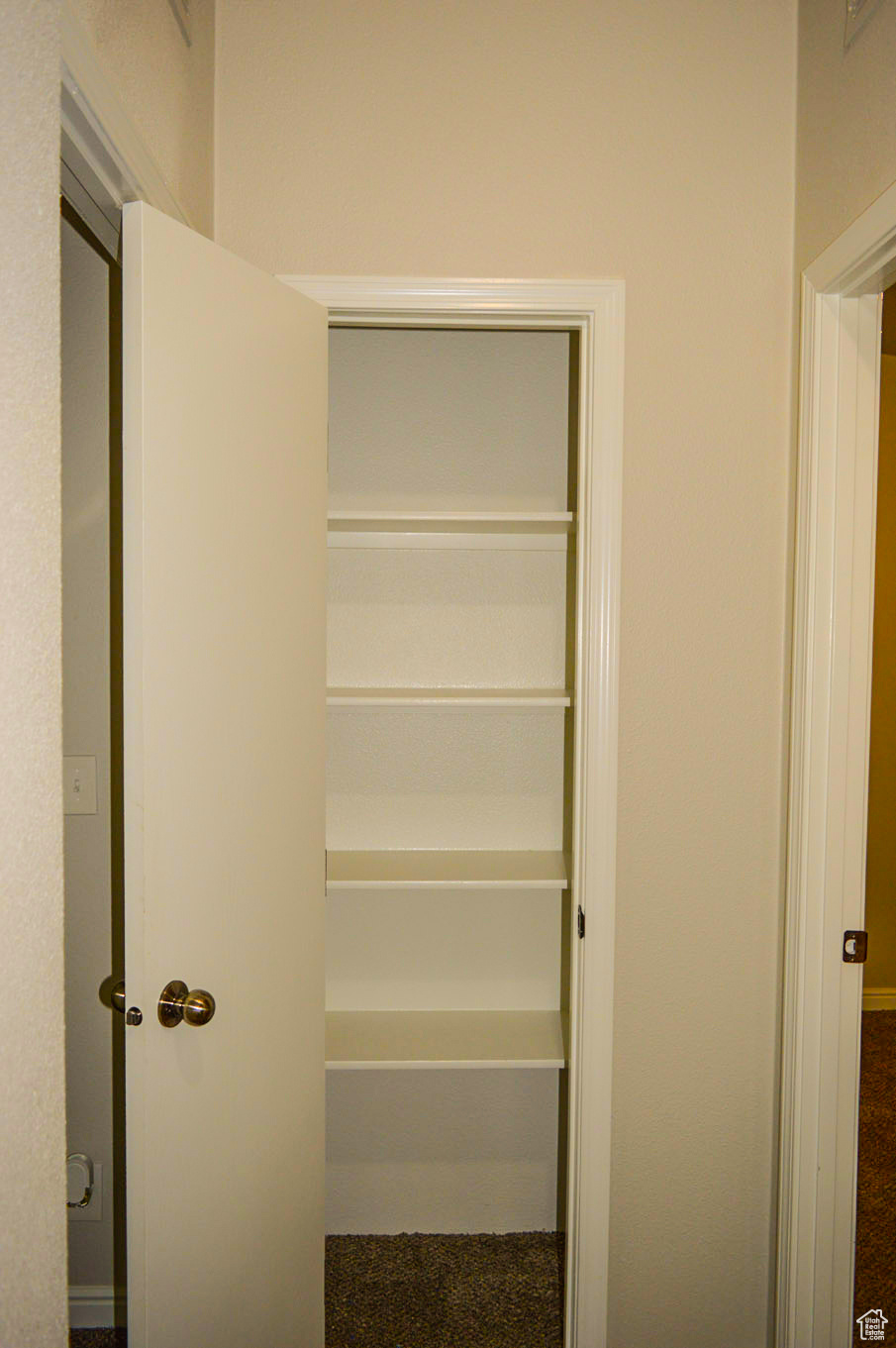 View of closet at end of hallway going to bedrooms 2 & 3