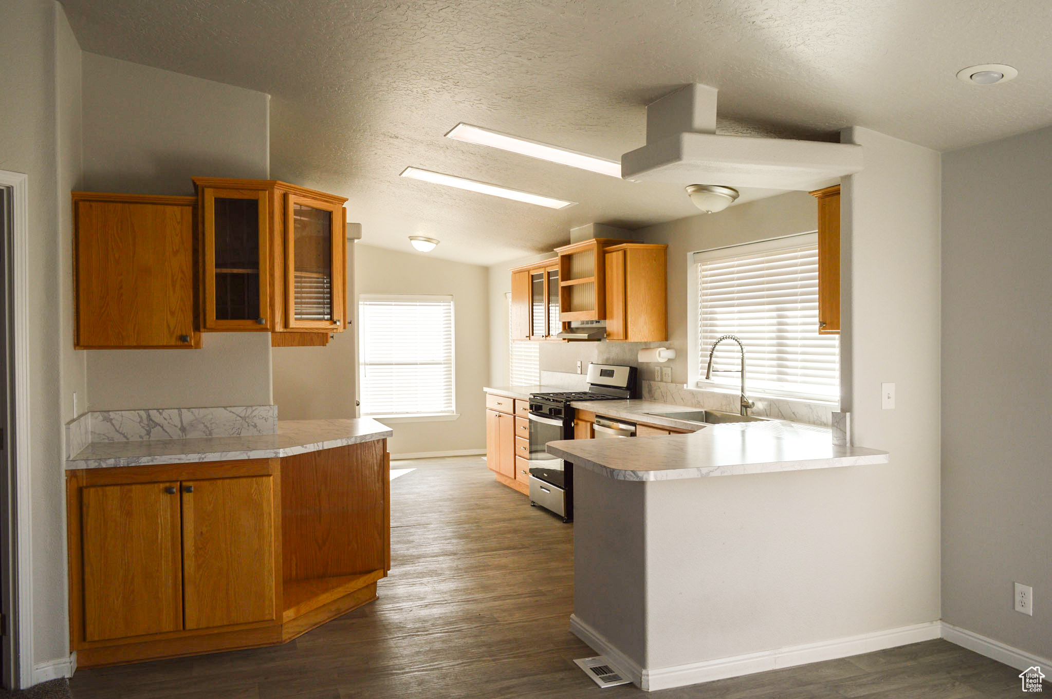 Kitchen features new countertop, new range, updated sink, new flooring, re-faced cabinets with new drawers and breakfast nook.