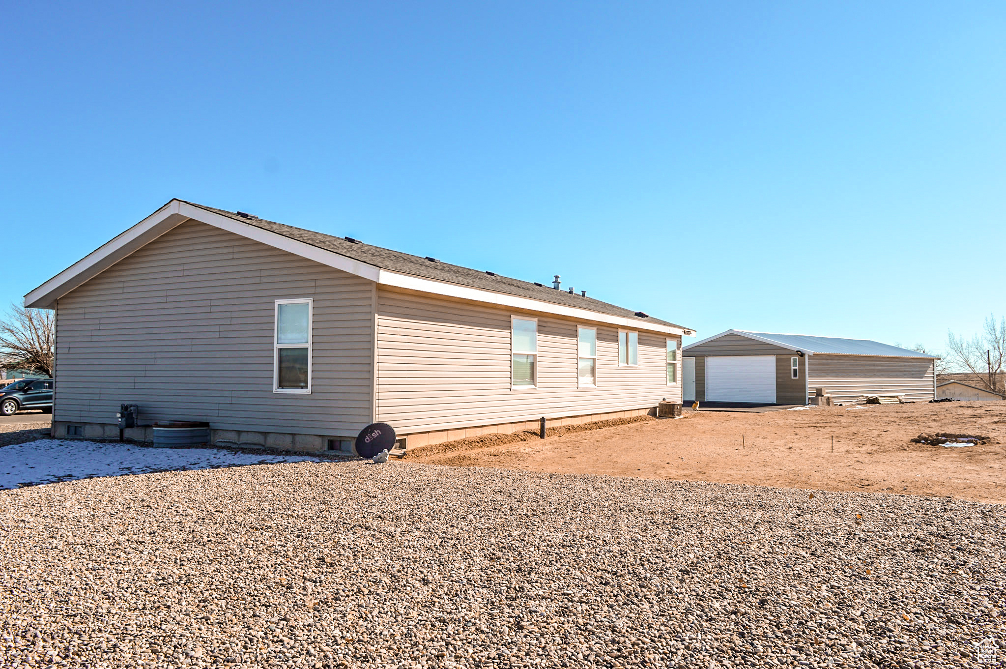 View of side of property featuring home and garage.