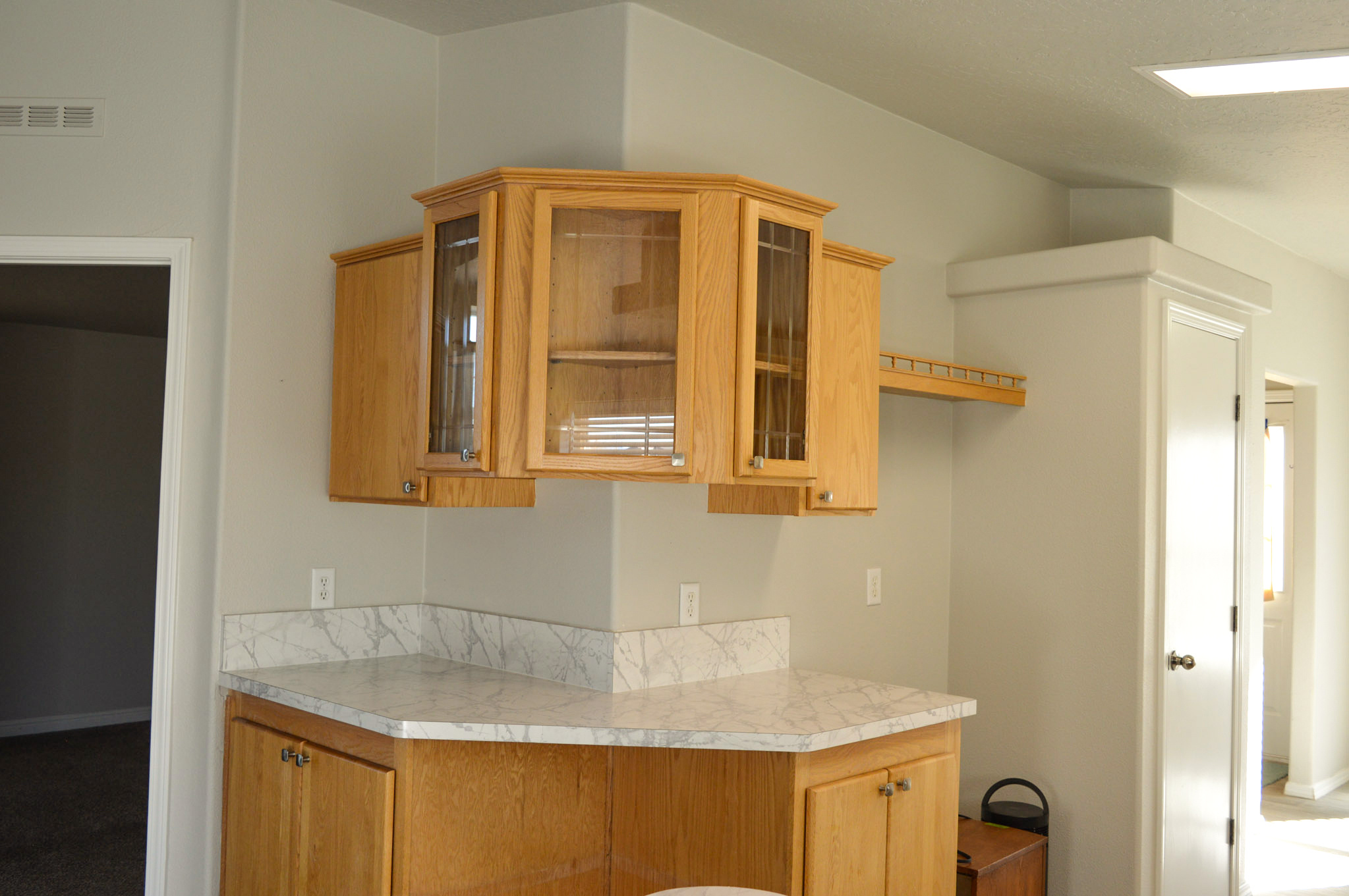 Corner cabinetry with enclosed display space