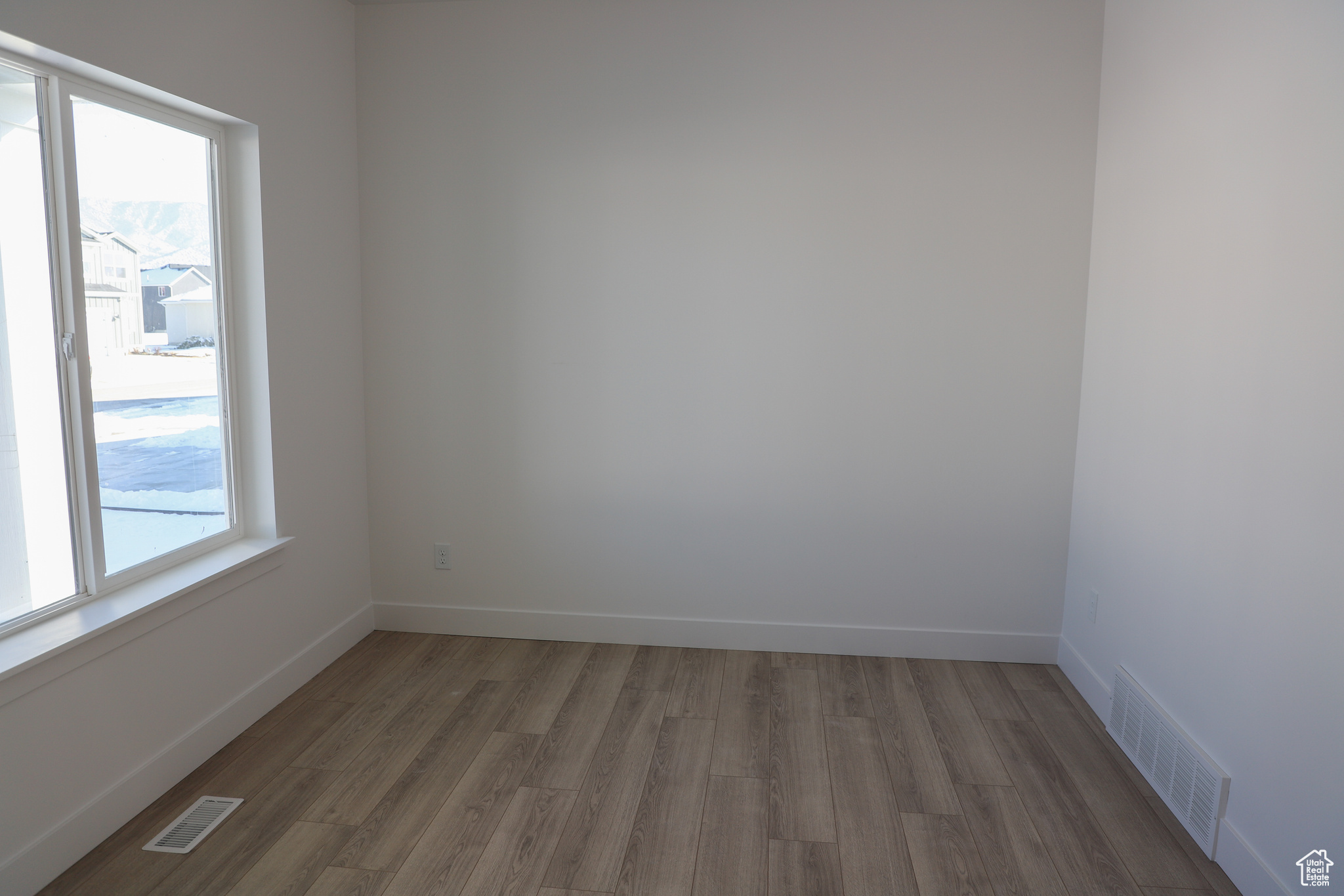 Unfurnished room featuring dark hardwood / wood-style floors