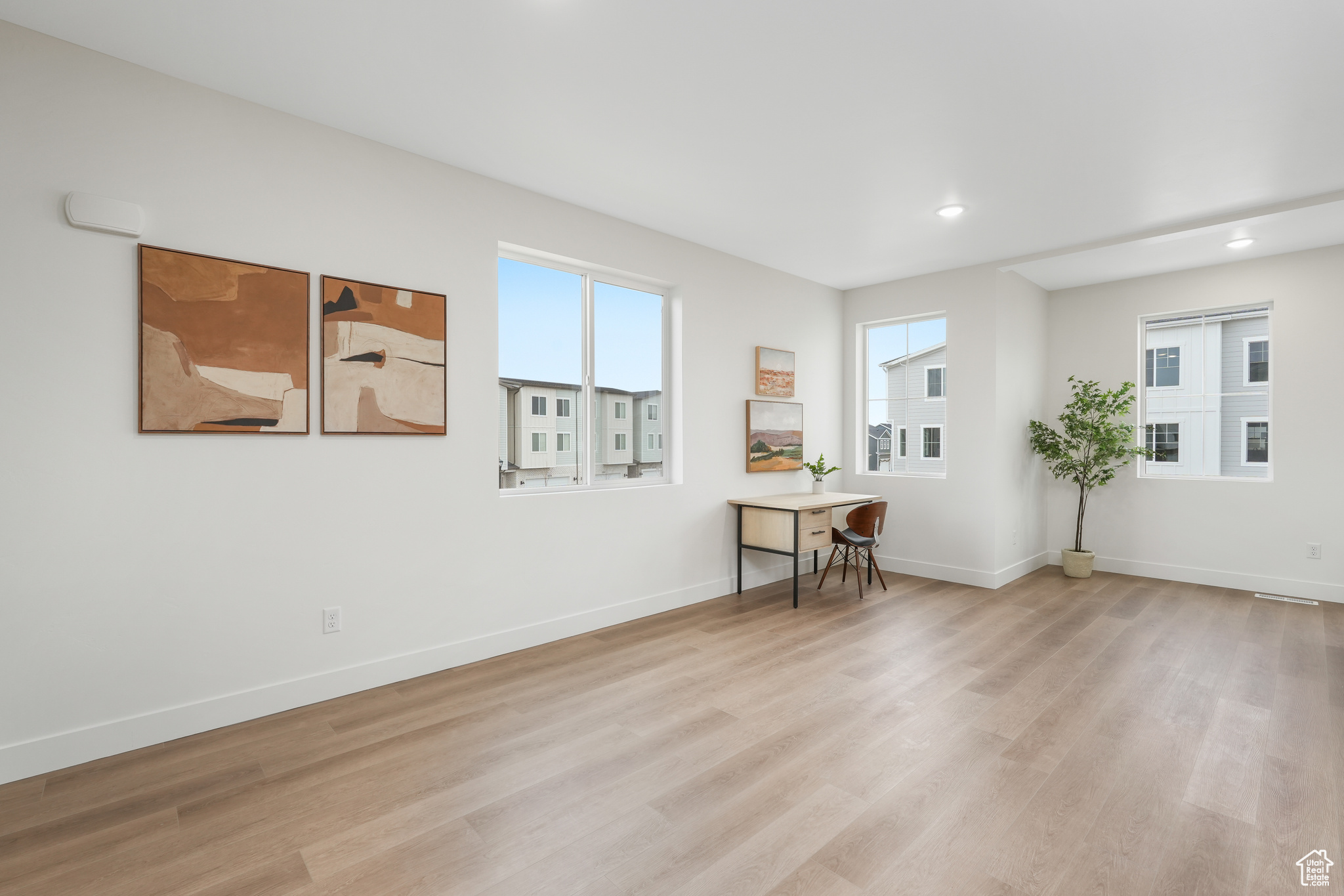 Spare room featuring light hardwood / wood-style floors and a wealth of natural light