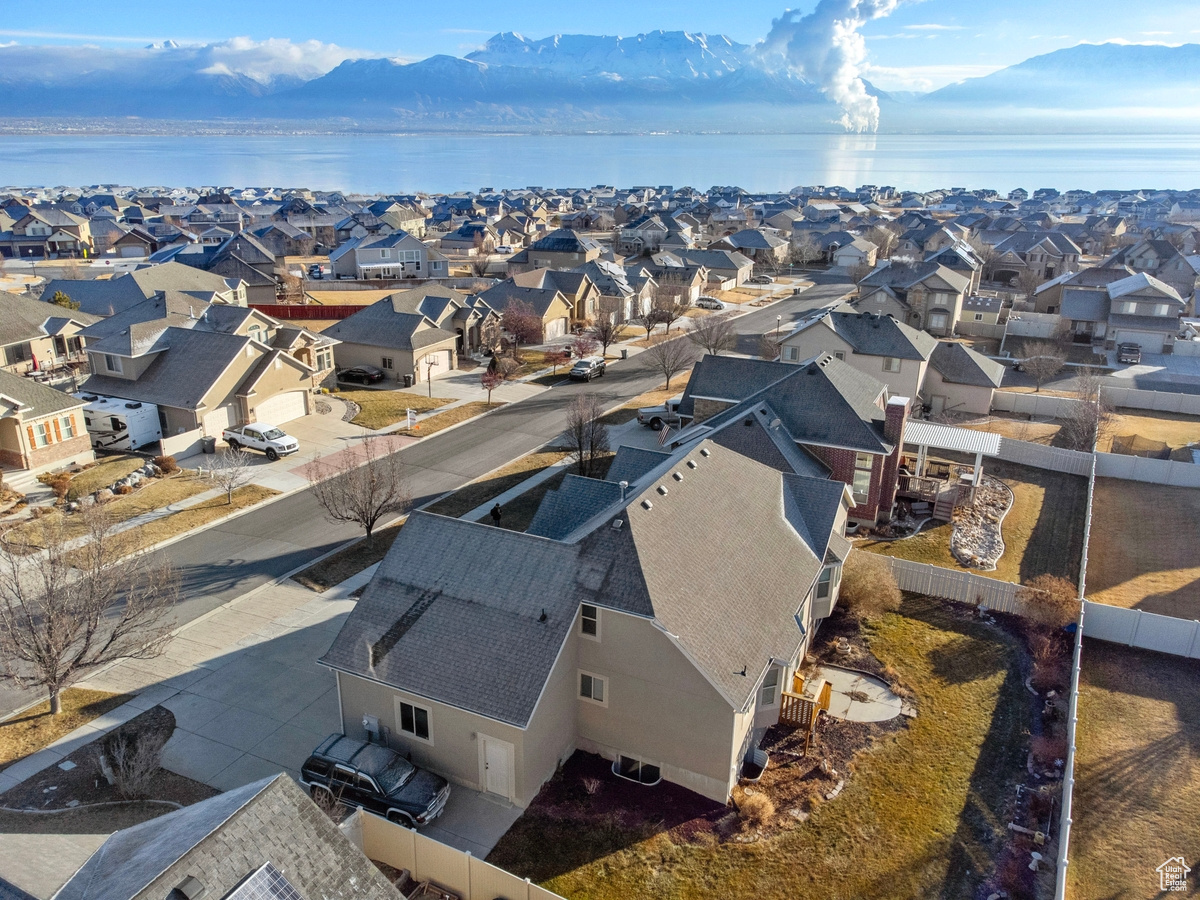 Birds eye view of property with a water and mountain view