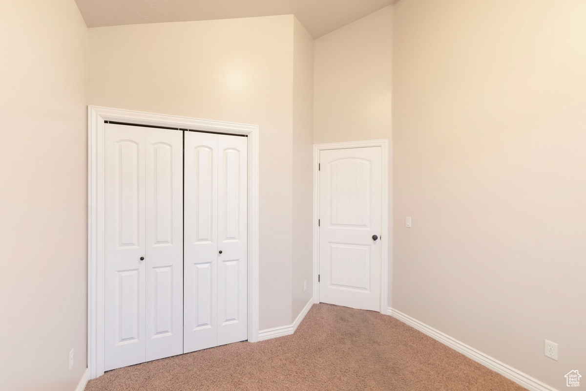 Unfurnished bedroom with carpet flooring and a closet
