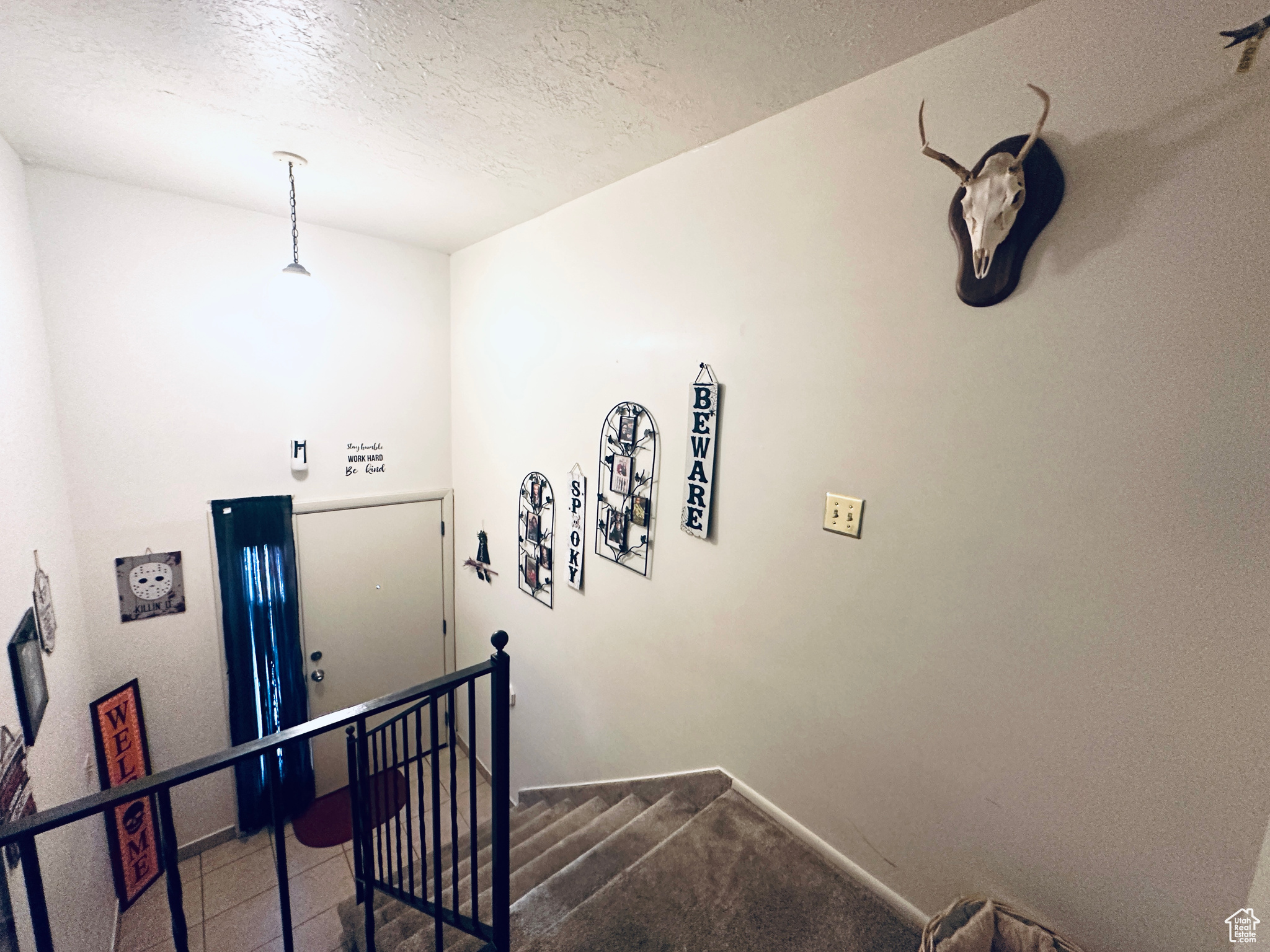 Stairway featuring a textured ceiling